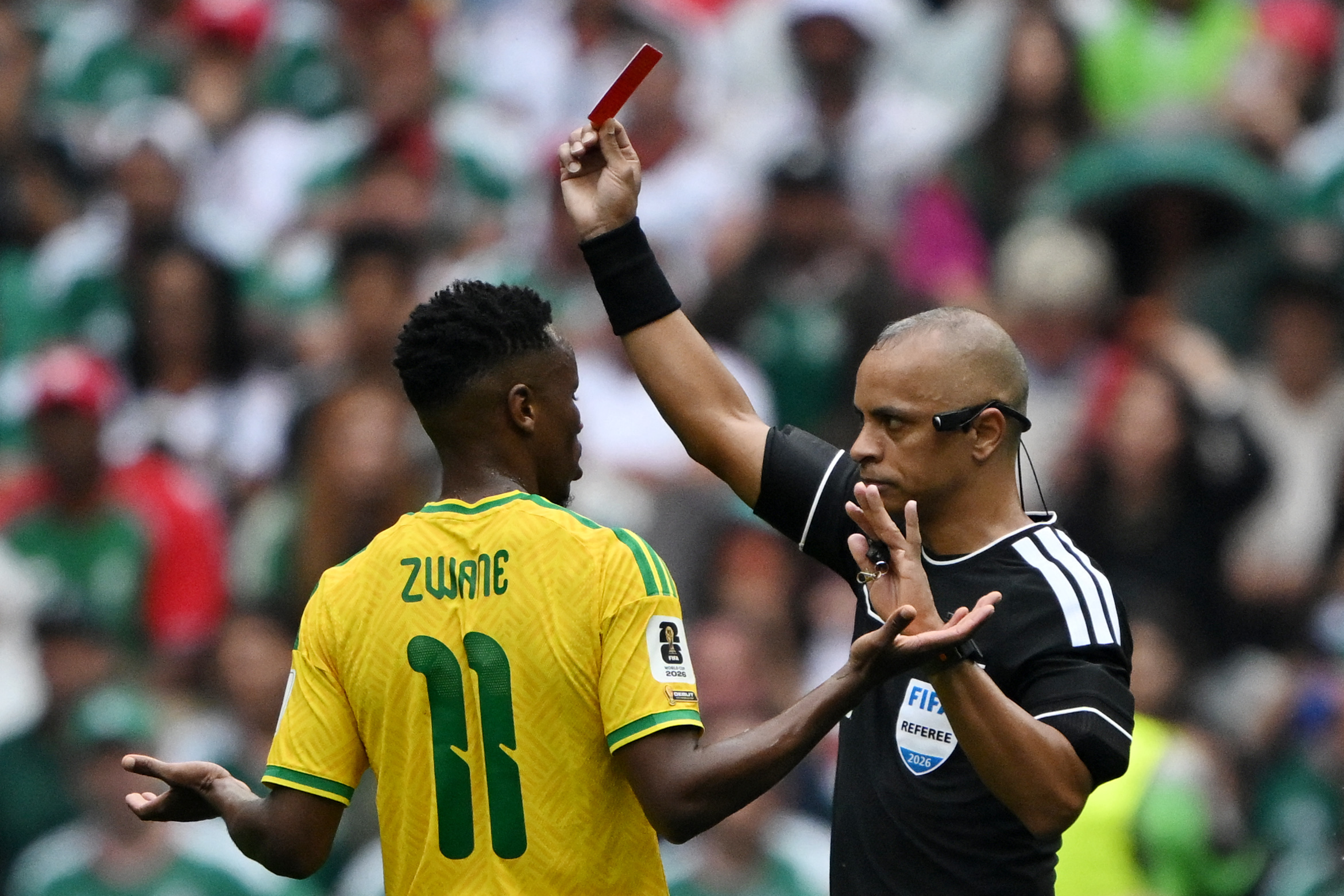 Brazilian referee Wilton Sampaio shows a red card to South Africa's midfielder #11 Themba Zwane.