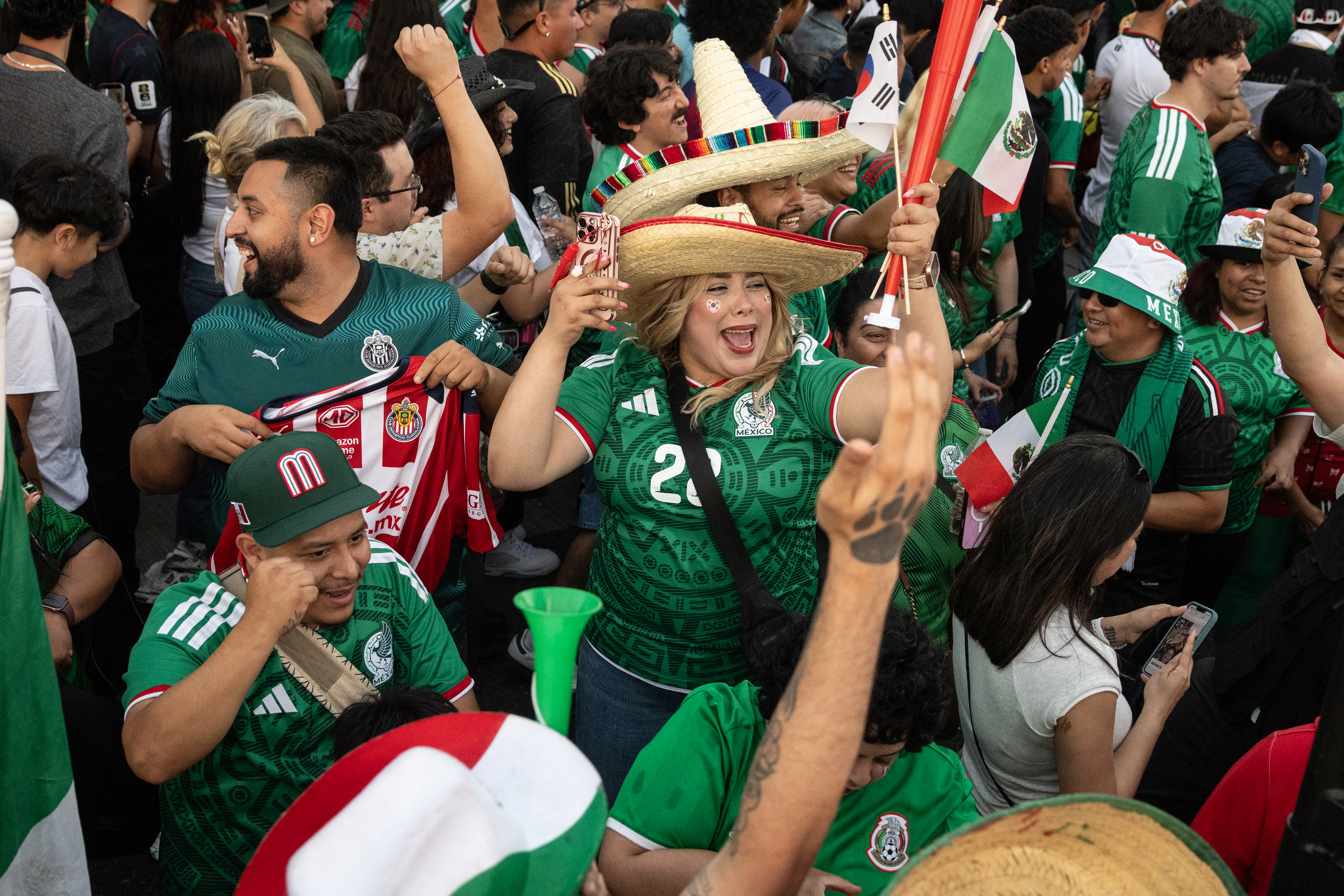 Mexico fans cheer after their team won the 2026 World Cup match between South Korea and Mexico at Seoul International Park in the Koreatown neighborhood of Los Angeles on June 18, 2026. (Photo by ETIENNE LAURENT / AFP)