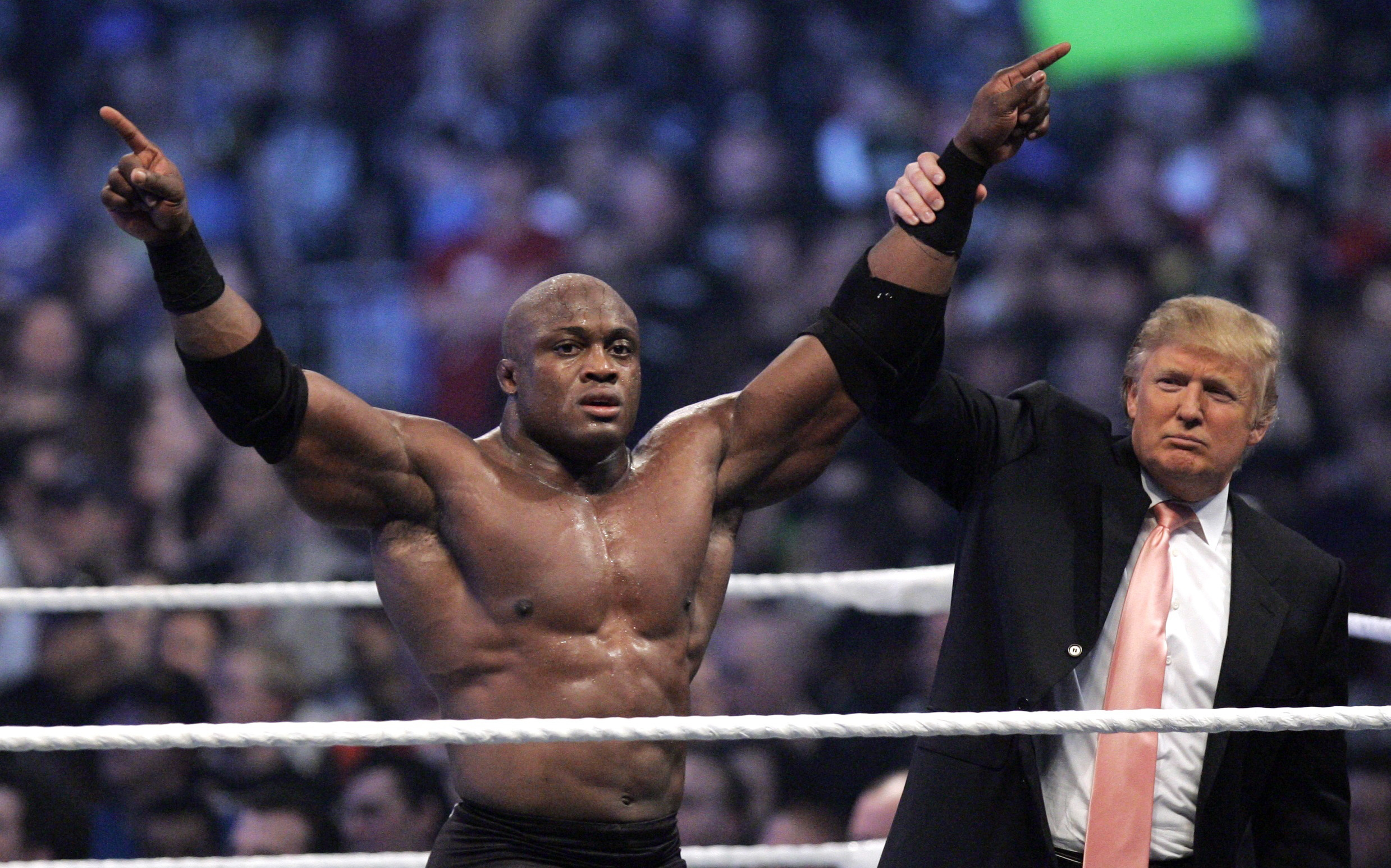 Trump raises the arm of wrestler Bobby Lashley after he defeated Umaga at Wrestlemania 23 in 2007 at Ford Field in Detroit, Michigan
