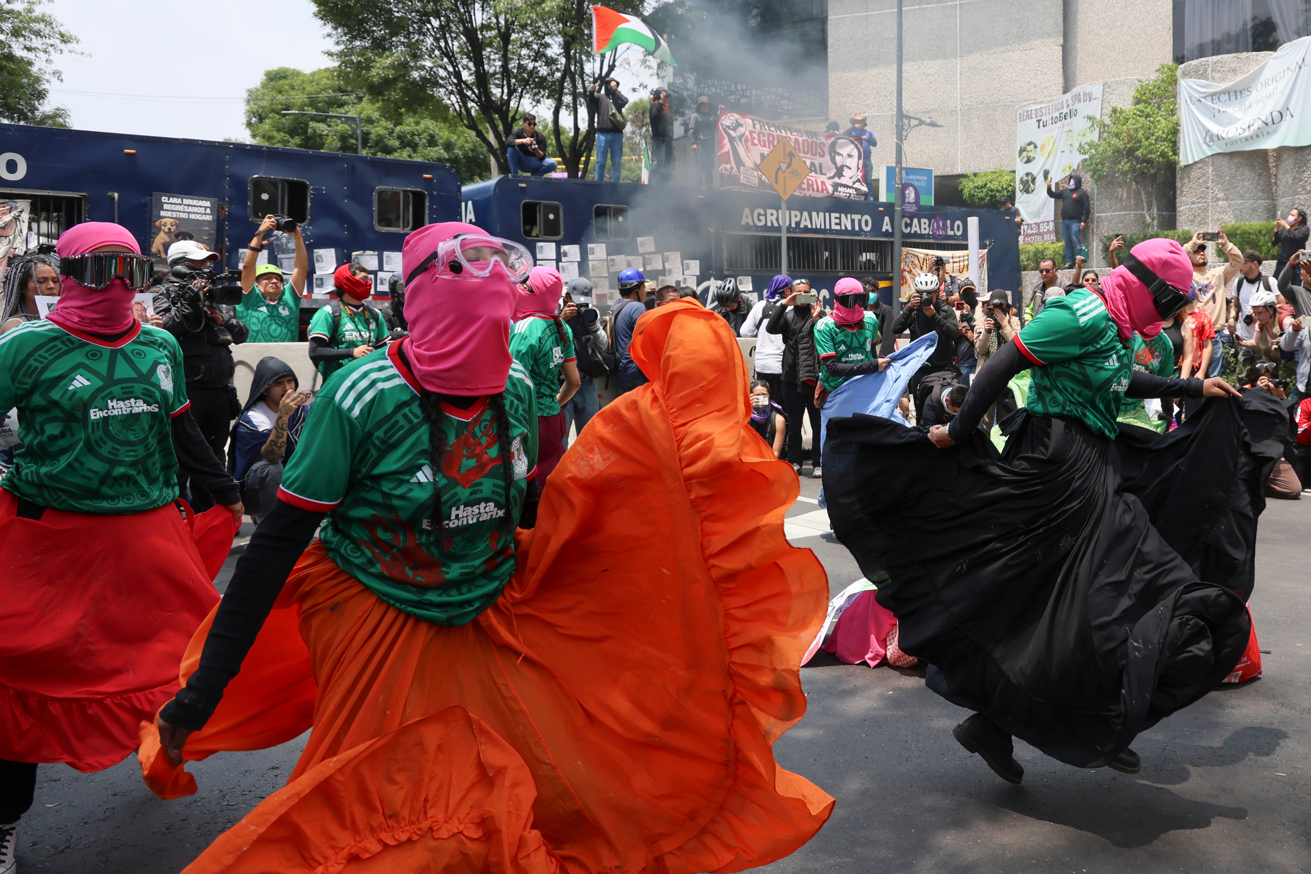 Demonstrators perform during a protest march, prior to the opening day