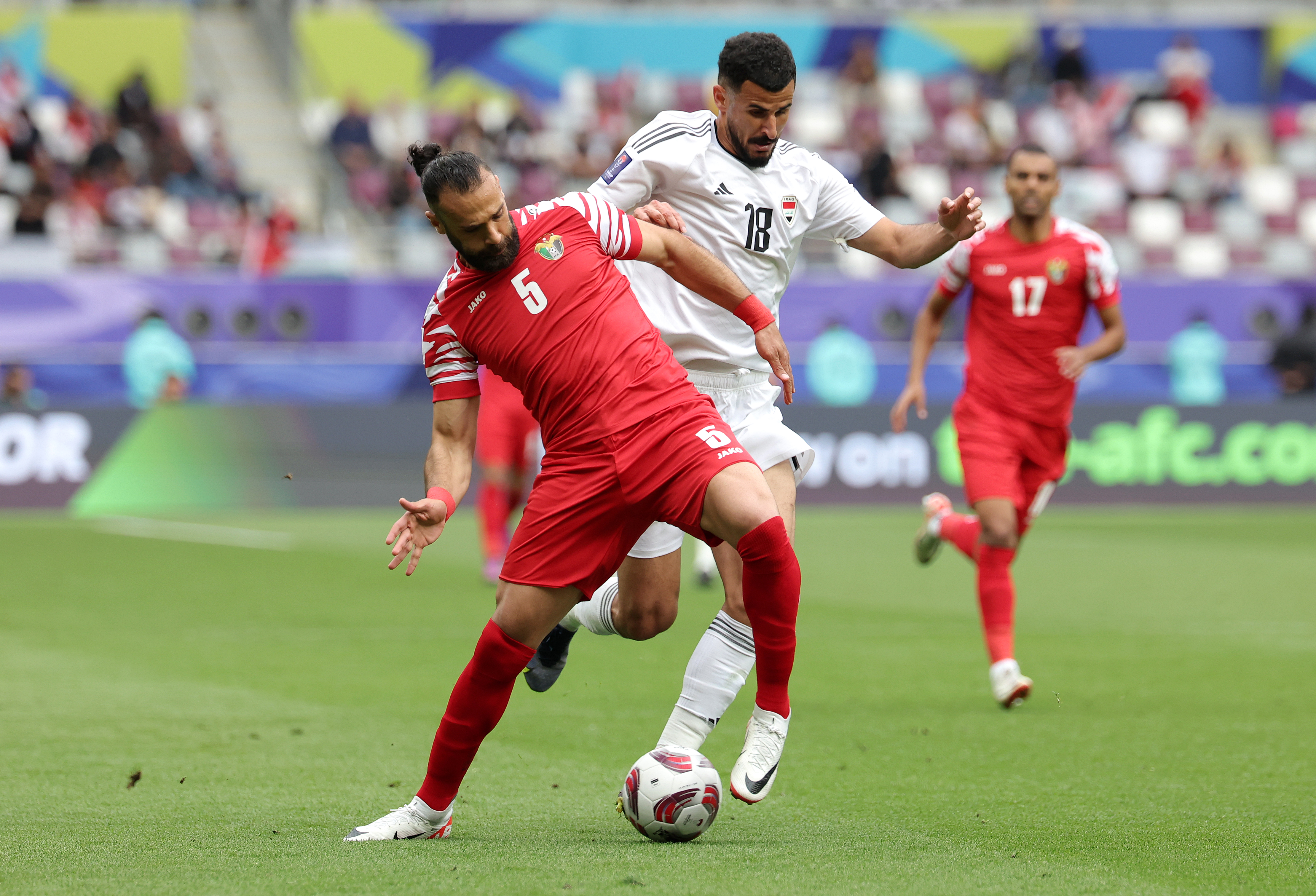 Jordan’s Yazan Al-Arab battles for possession with Iraq’s Aymen Hussein during the AFC Asian Cup match between Iraq and Jordan on January 29, 2024, at Khalifa International Stadium in Doha, Qatar