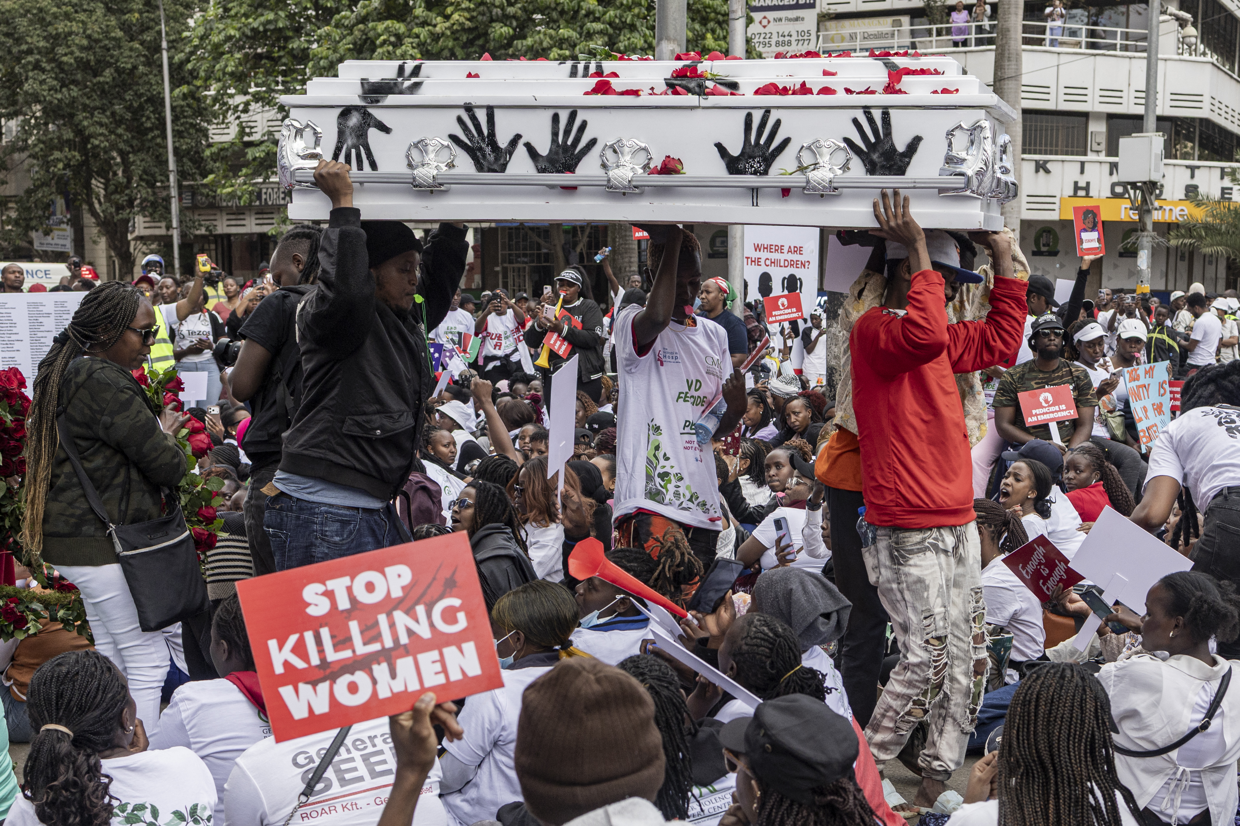 Protesters carry an empty coffin as they stage a sit in during a protest against femicide, in Nairobi on June 1, 2026.