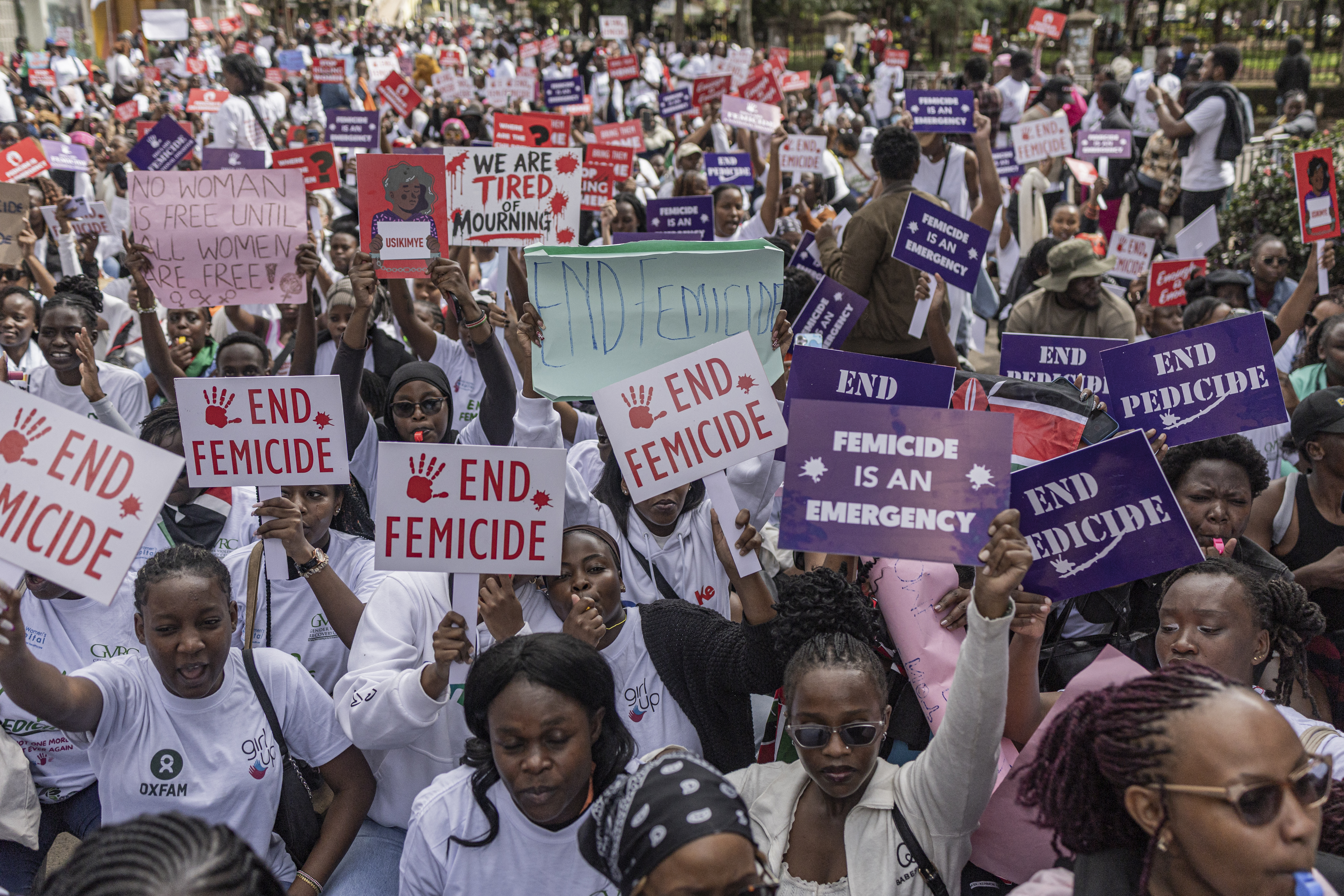 Kenyan women and activists hold placards during a protest against femicide, in Nairobi on June 1, 2026.
