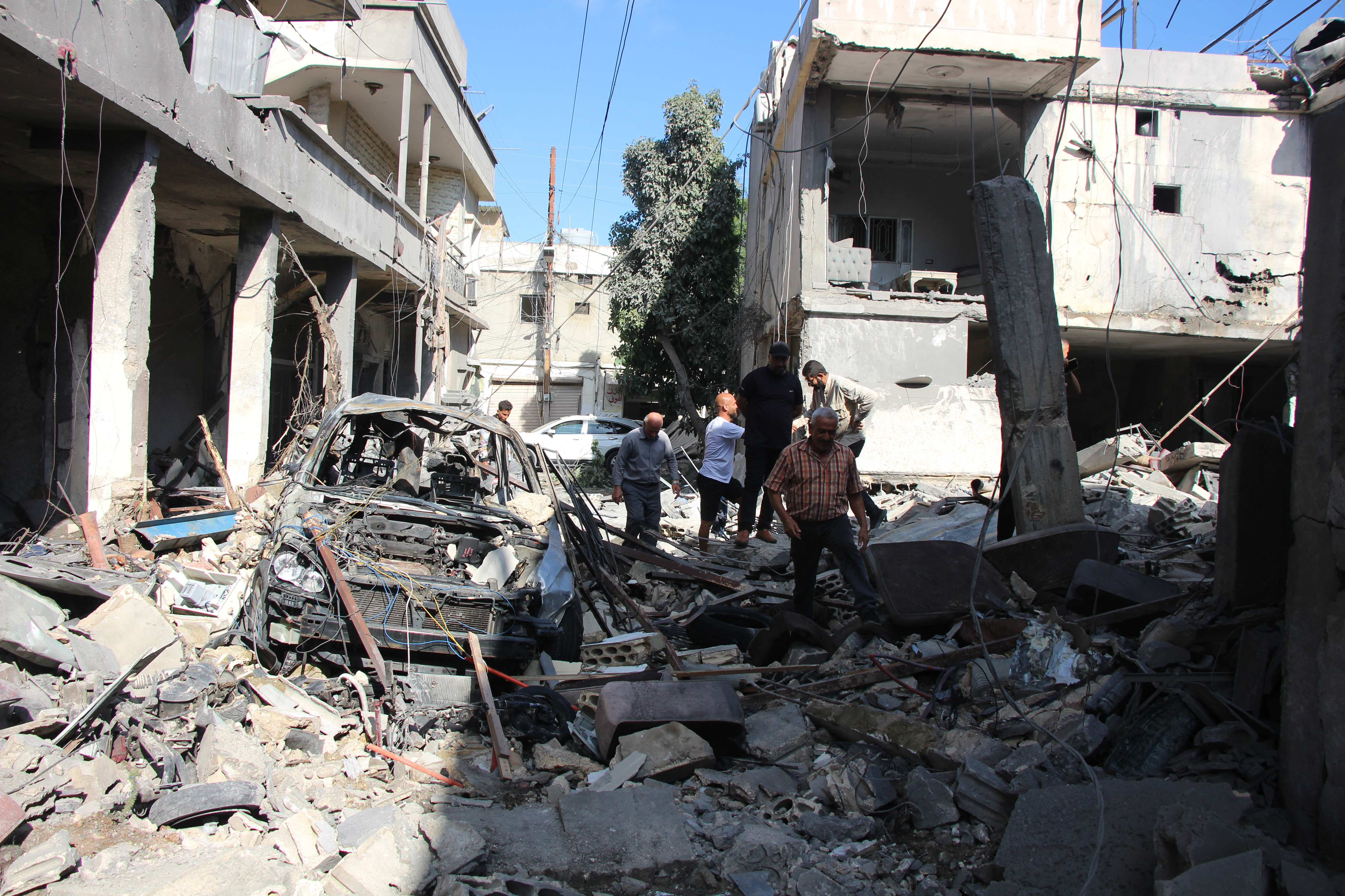 People inspect the aftermath at the site of an Israeli strike that hit the previous day in the southern Lebanese coastal city of Tyre on June 5, 2026.