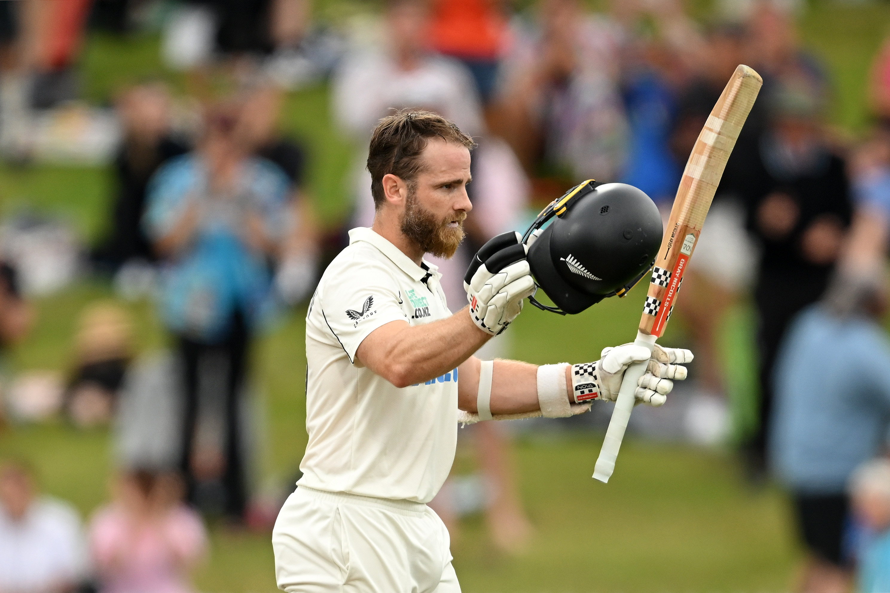 HAMILTON, NEW ZEALAND - DECEMBER 16: Kane Williamson of New Zealand raises his bat after bringing up his century during day three of the Third Test Match in the series between New Zealand and England at Seddon Park on December 16, 2024 in Hamilton, New Zealand. (Photo by Hannah Peters/Getty Images)