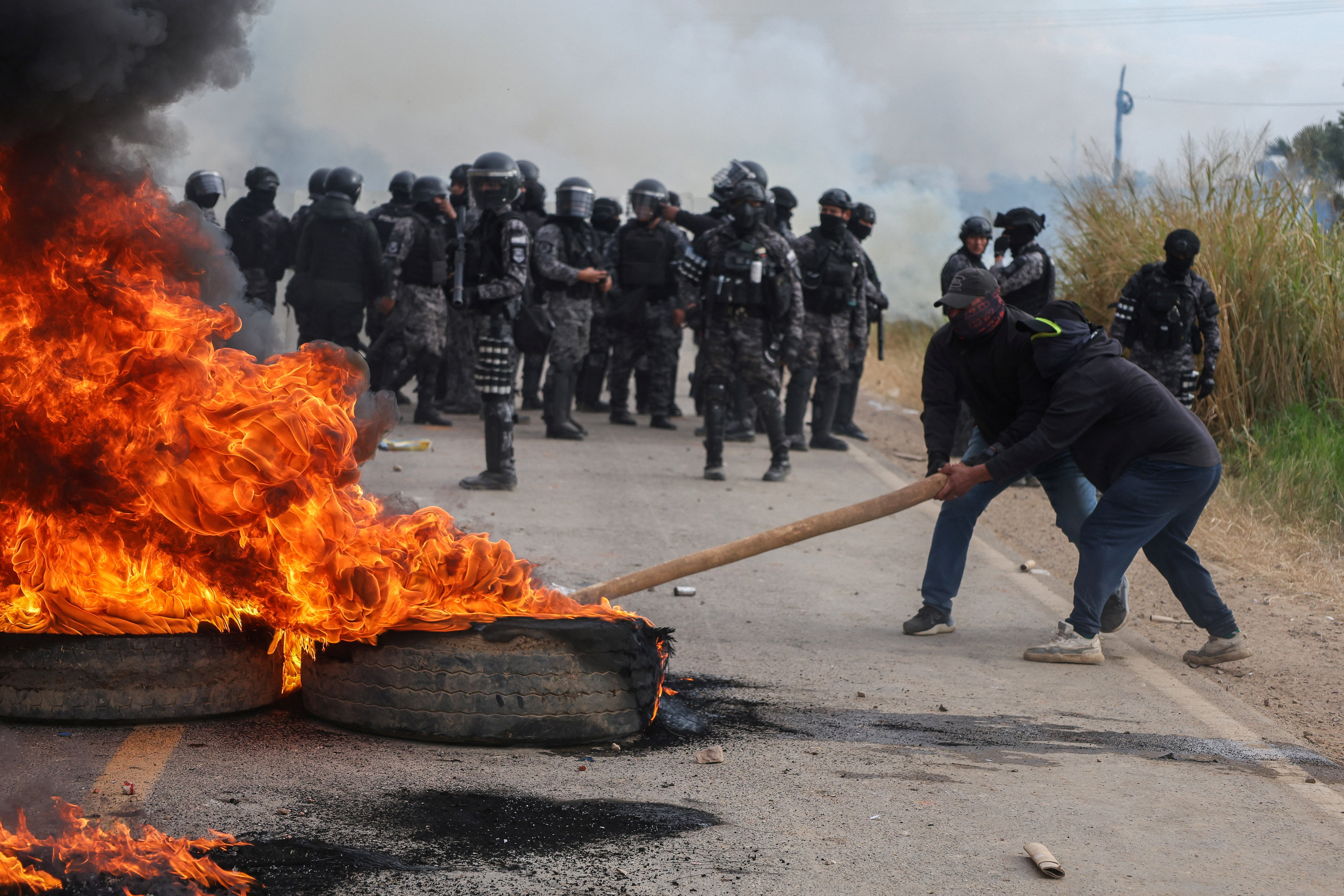 People try to put out a fire set up by demonstrators blocking a highway in a protest against Bolivia's President Rodrigo Paz in San Julian, Bolivia, June 6, 2026. REUTERS/Ipa Ibanez
