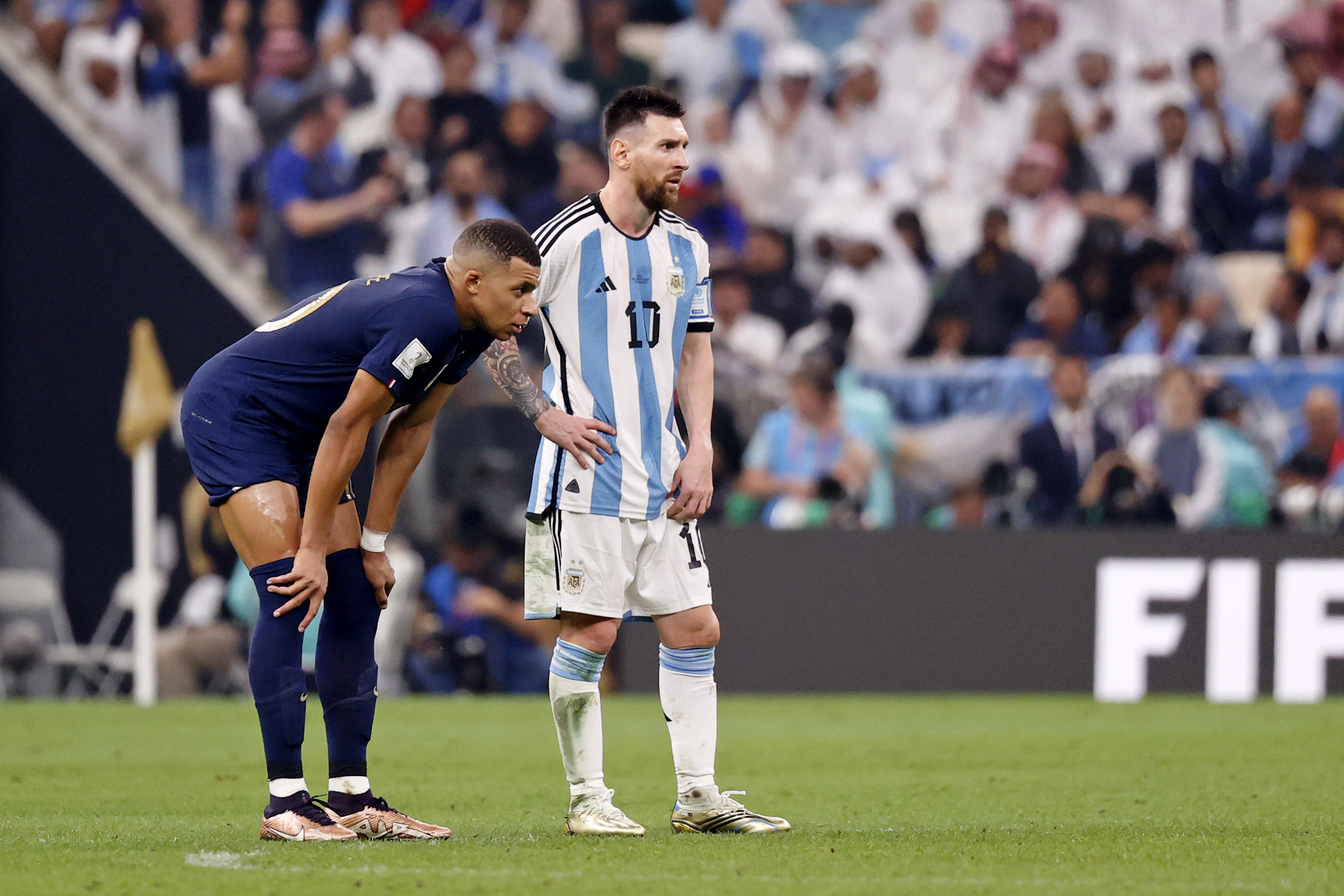 France forward Kylian Mbappe (10) stands next to Argentina forward Lionel Messi (10) before the start of extra time of the 2022 World Cup final 
