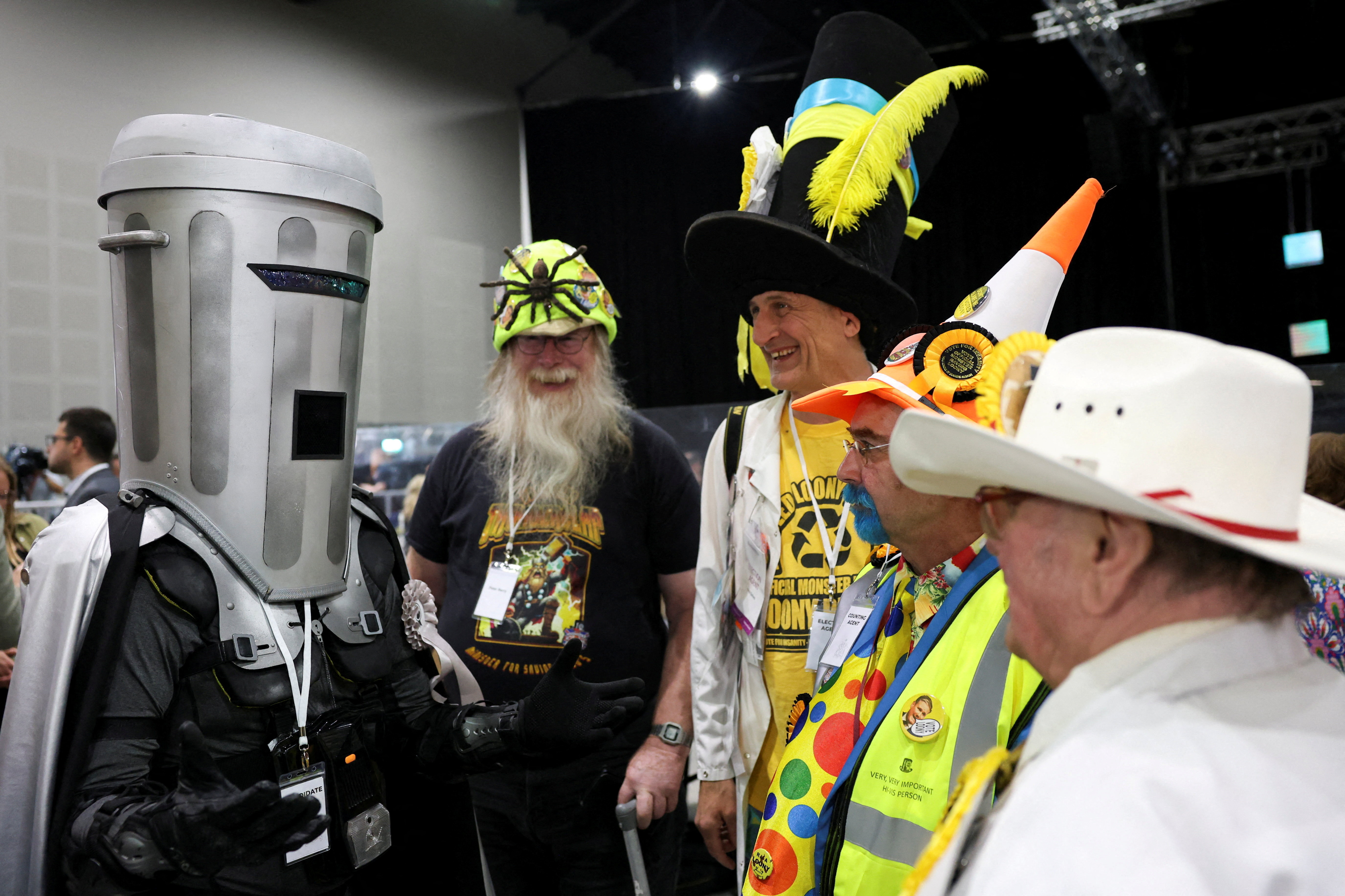 Count Binface speaks to members of the Monster Raving Loony Party during the vote counting for the Makerfield by-election, triggered by the resignation of Labour MP John Simons, in Wigan, UK, June 19, 2026