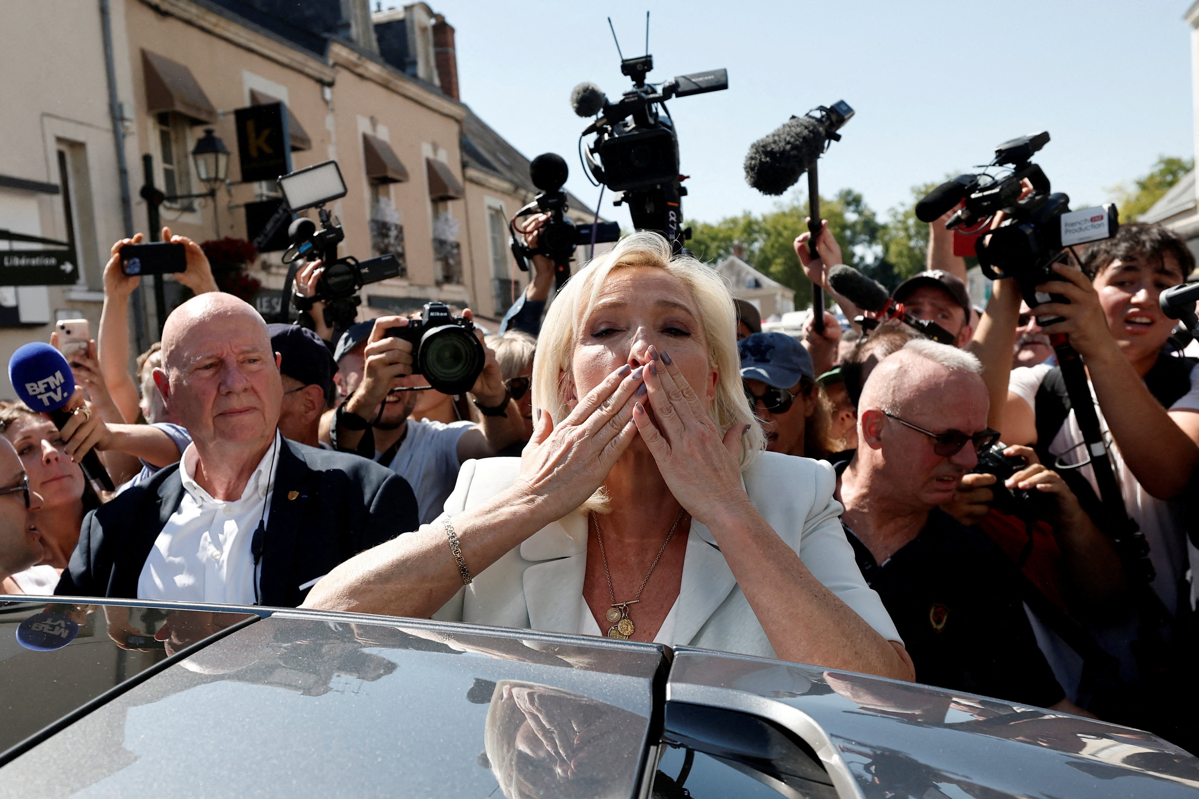 French far-right leader Marine Le Pen blows a kiss to supporters as she leaves after a visit at a market with Jordan Bardella, president of the French far-right Rassemblement National (National Rally - RN) political party, in La Fleche, in the Sarthe department, a day after Le Pen announced her candidacy for the 2027 French presidential election following an appeals court ruling that shortened her ban on running for office while upholding her conviction for embezzling EU funds, France, July 8, 2026. REUTERS/Benoit Tessier TPX IMAGES OF THE DAY