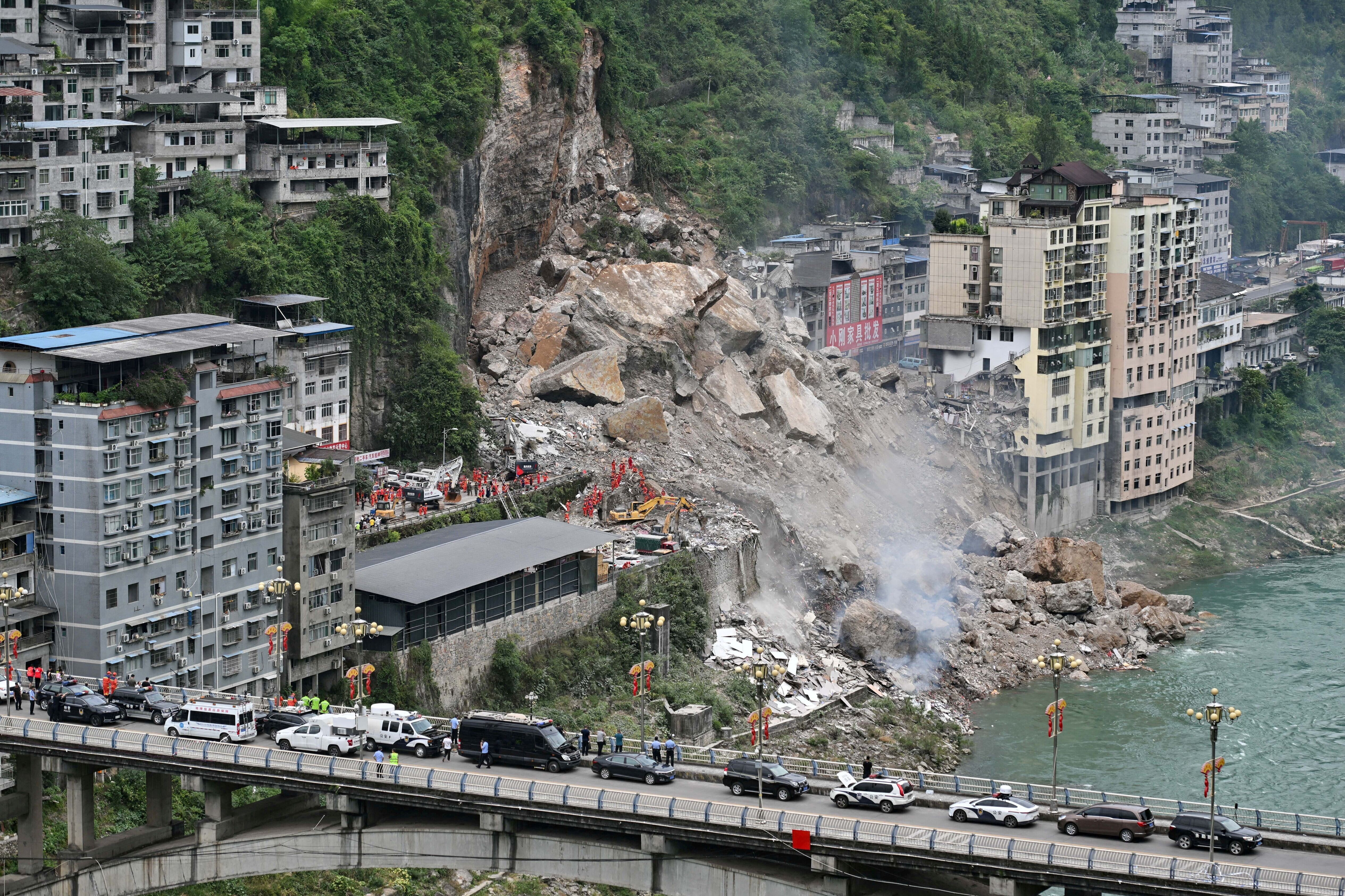 Wide view of a landslide on a hillside in Chongqing, China, seen from a distance.
