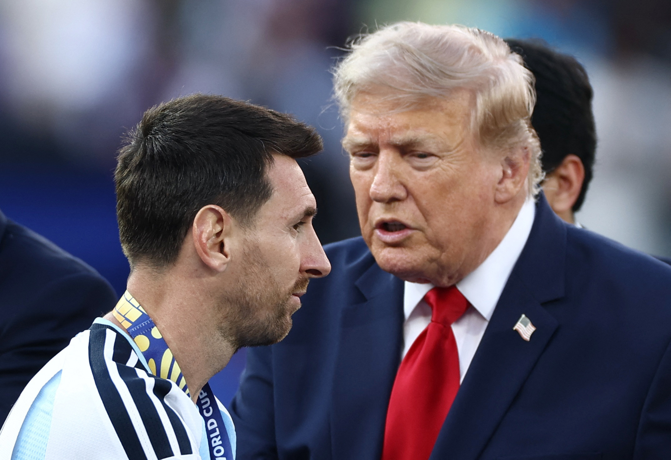 Argentina's Lionel Messi collects his runners-up medal during the trophy ceremony as U.S. President Donald Trump looks on