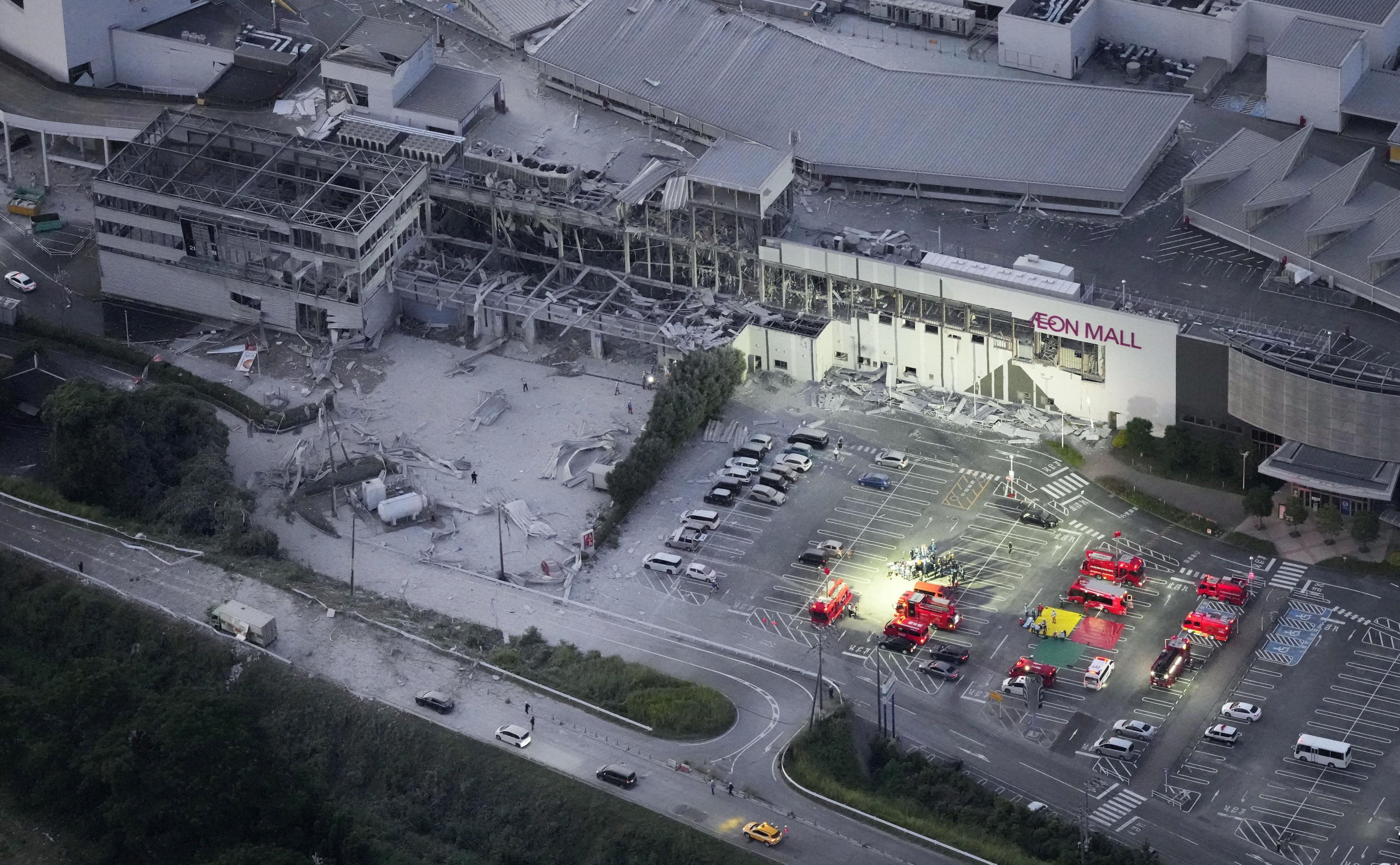 An aerial view shows rescue workers conducting a search and rescue operation at the damaged Aeon Mall 