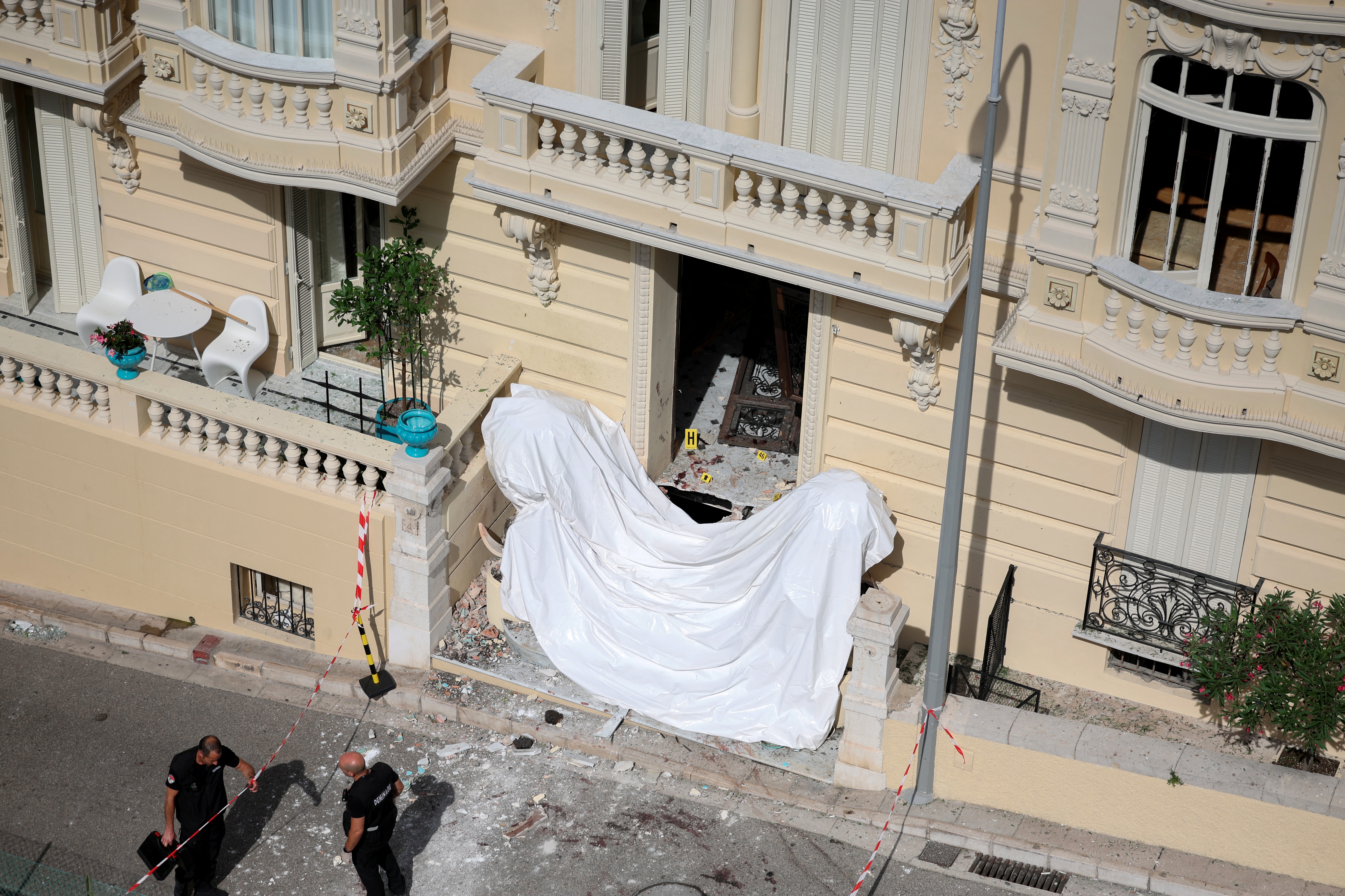 Members of a bomb disposal team work on June 30, 2026, at the site of an alleged attack involving an explosive device in the lobby of a residential building in Monaco that reportedly injured a Ukrainian oligarch, his son and partner