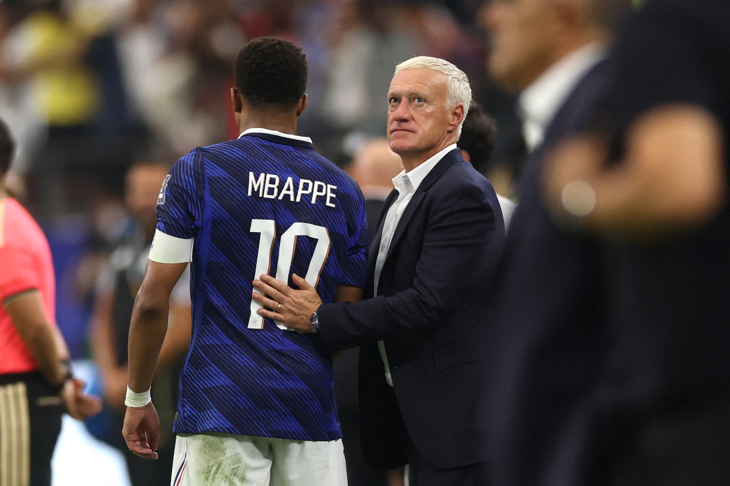 France manager Didier Deschamps, right, reacts with Kylian Mbappe after the 2-0 loss to Spain in the first semifinal