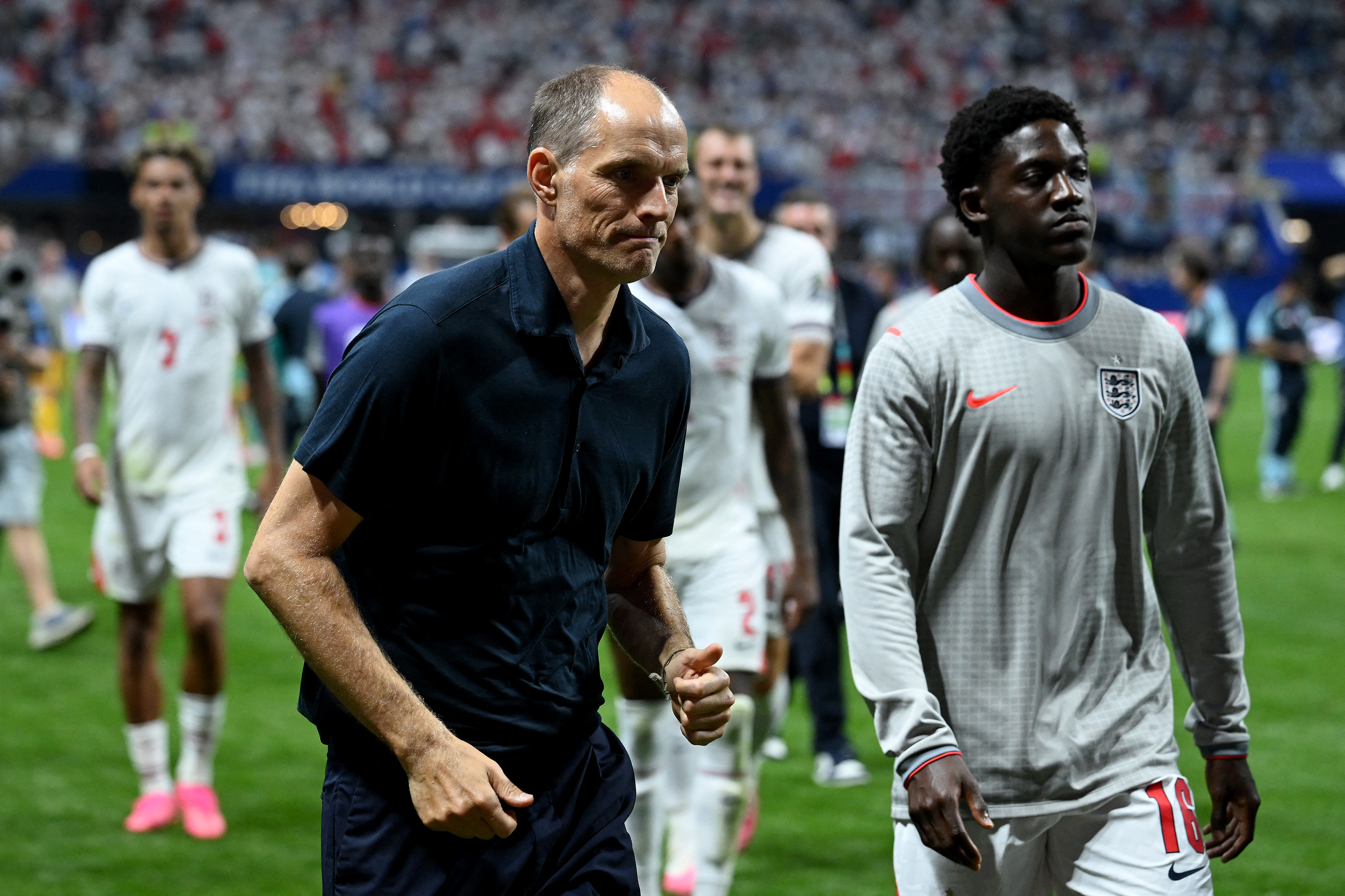 England manager Thomas Tuchel, left, walks off the pitch with Kobbie Mainoo after the 2-1 loss against Argentina in Atlanta