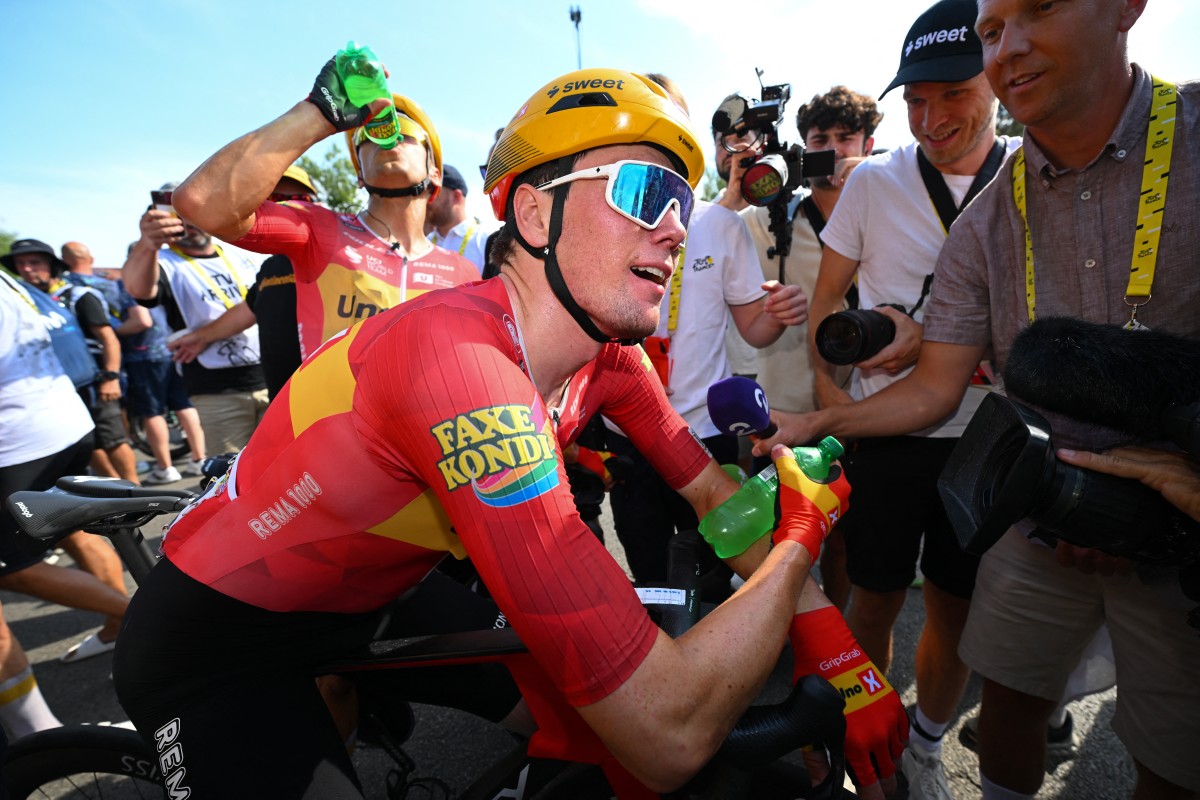 Uno-X Mobility team's Norwegian rider Soren Waerenskjold celebrates after winning the 11th stage of the 113th edition of the Tour de France cycling race