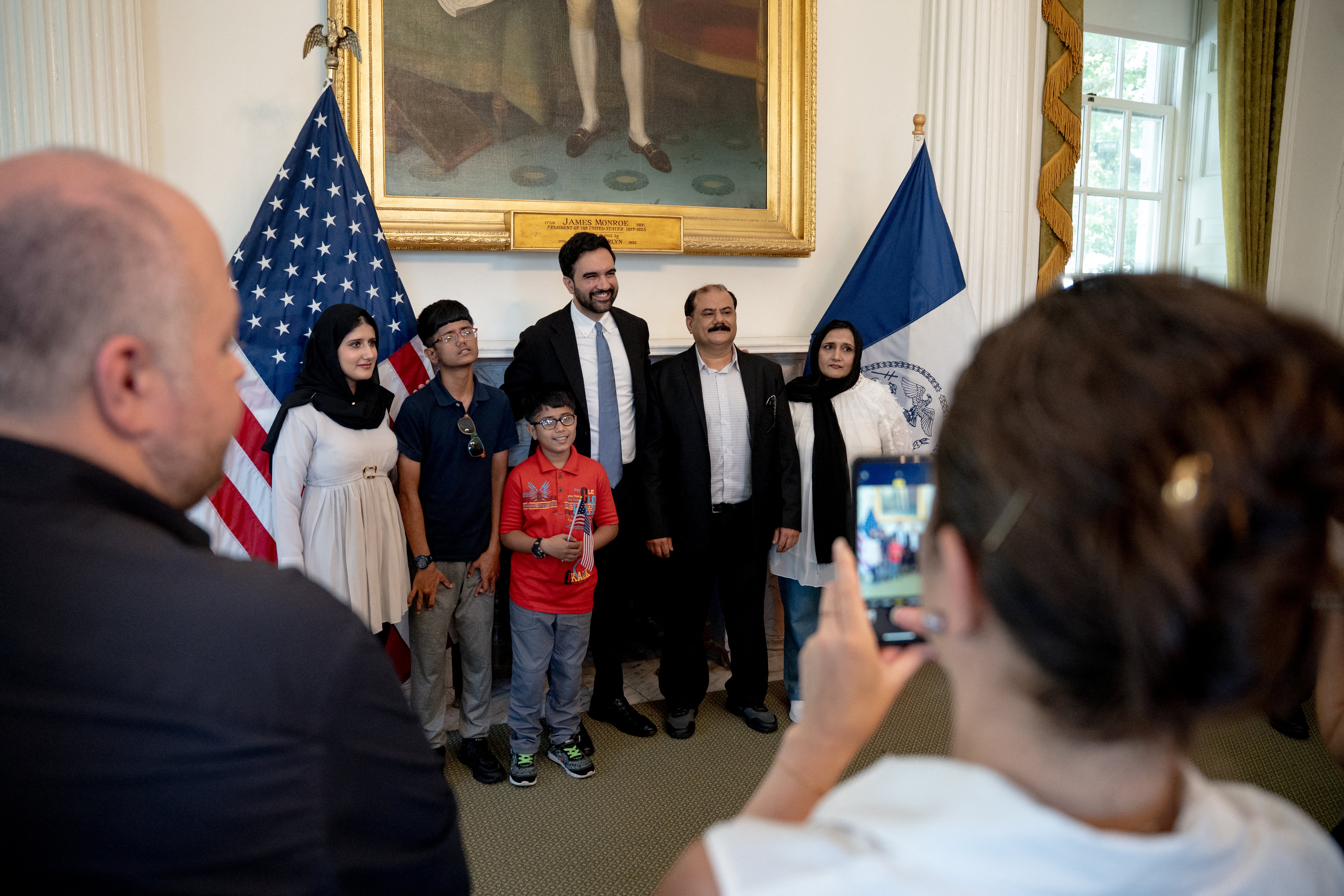 New York City Mayor Zohran Mamdani poses with a group of recently naturalized US citizens after he delivered a speech to mark the 250th anniversary of the United States of America at City Hall on July 3, 2026 in New York. (Photo by Anna CONNORS / POOL / AFP)