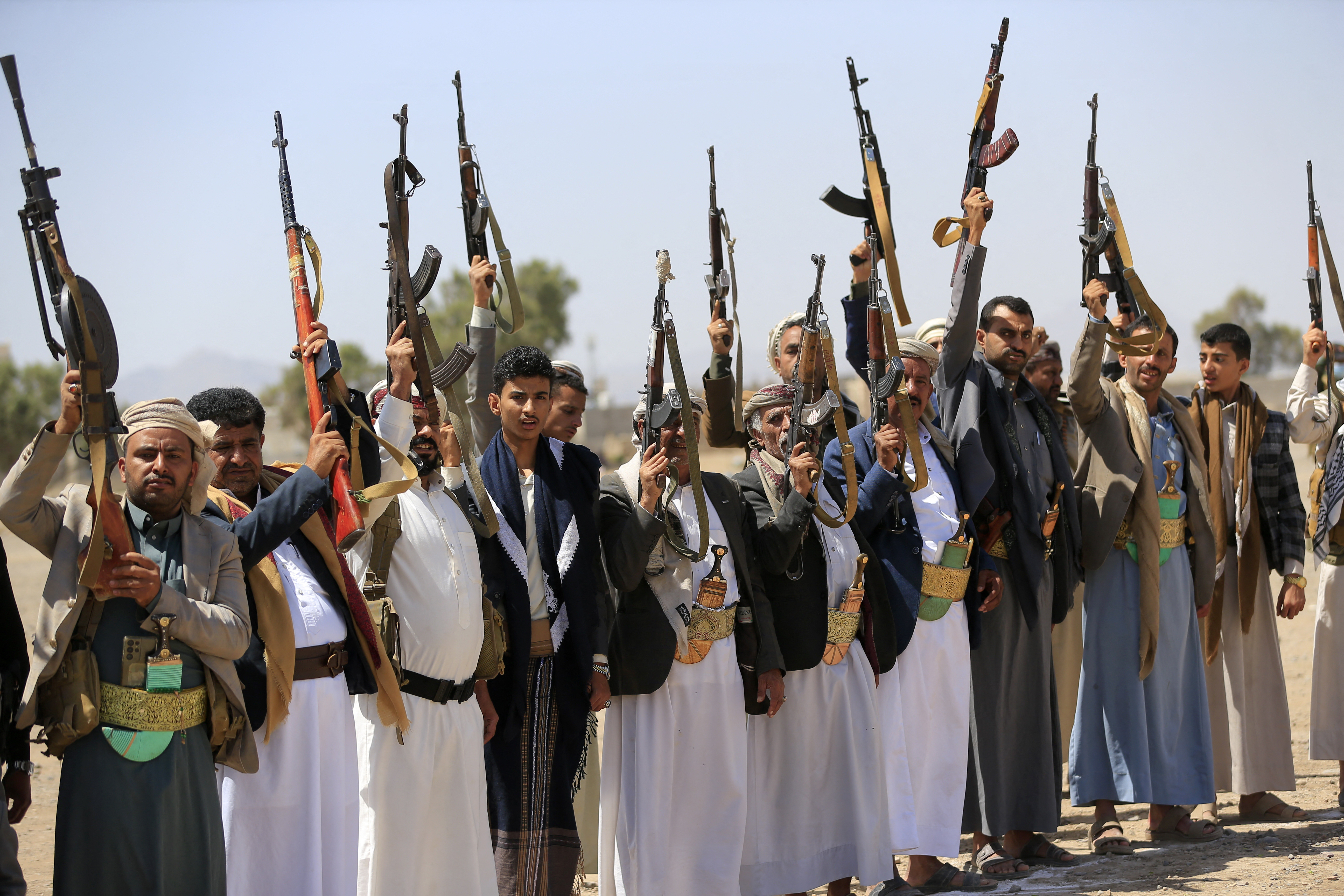 Armed Yemenis brandish their weapons as they rally in solidarity with Lebanon and Iran on the outskirts of the Huthi-controlled capital Sanaa on July 2, 2026.