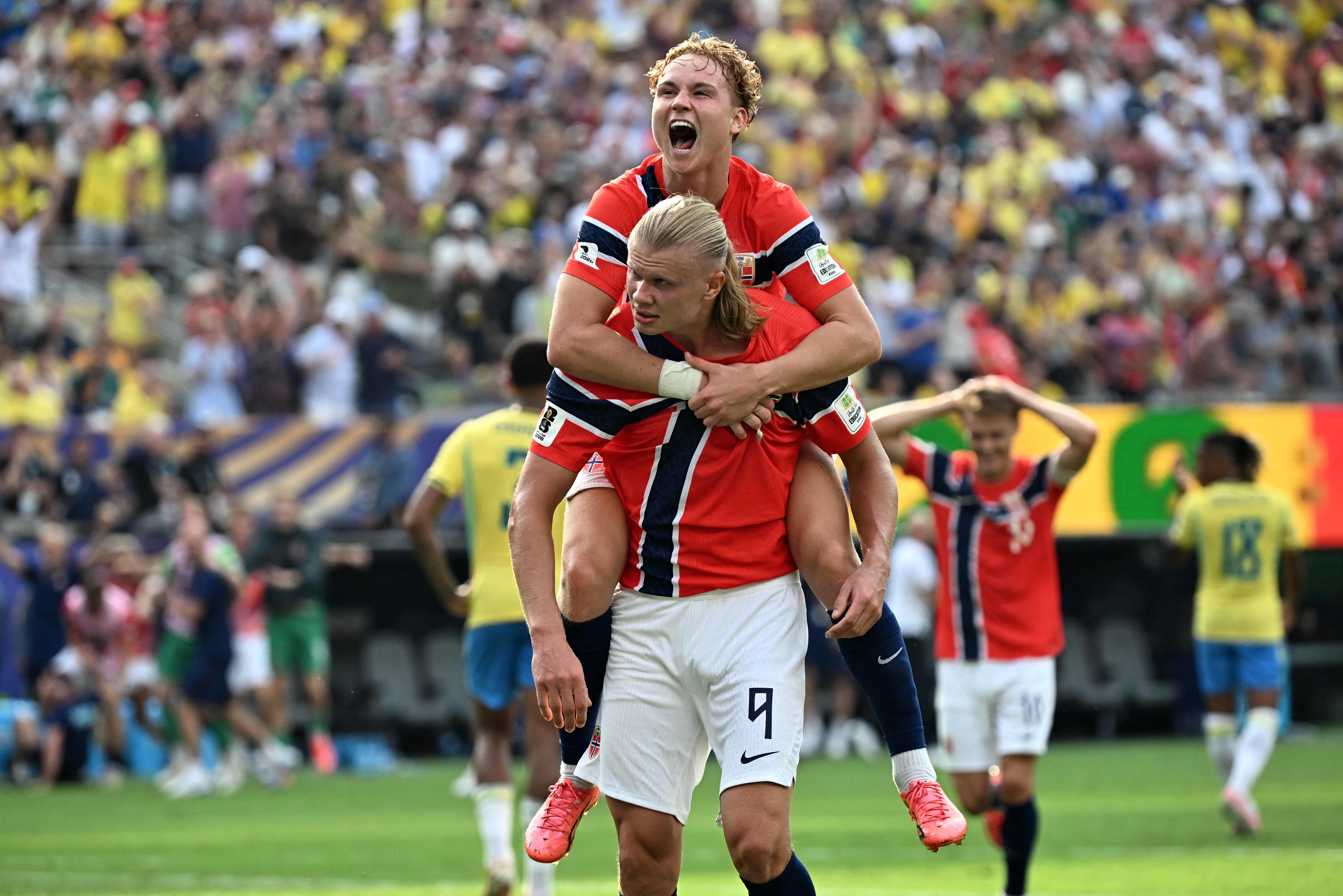 Norway's forward #09 Erling Braut Haaland celebrates scoring his team's second goal with teammate midfielder #21 Andreas Schjelderup during the 2026 World Cup round of 16 football match between Brazil and Norway at the New York/New Jersey Stadium in East Rutherford on July 5, 2026.