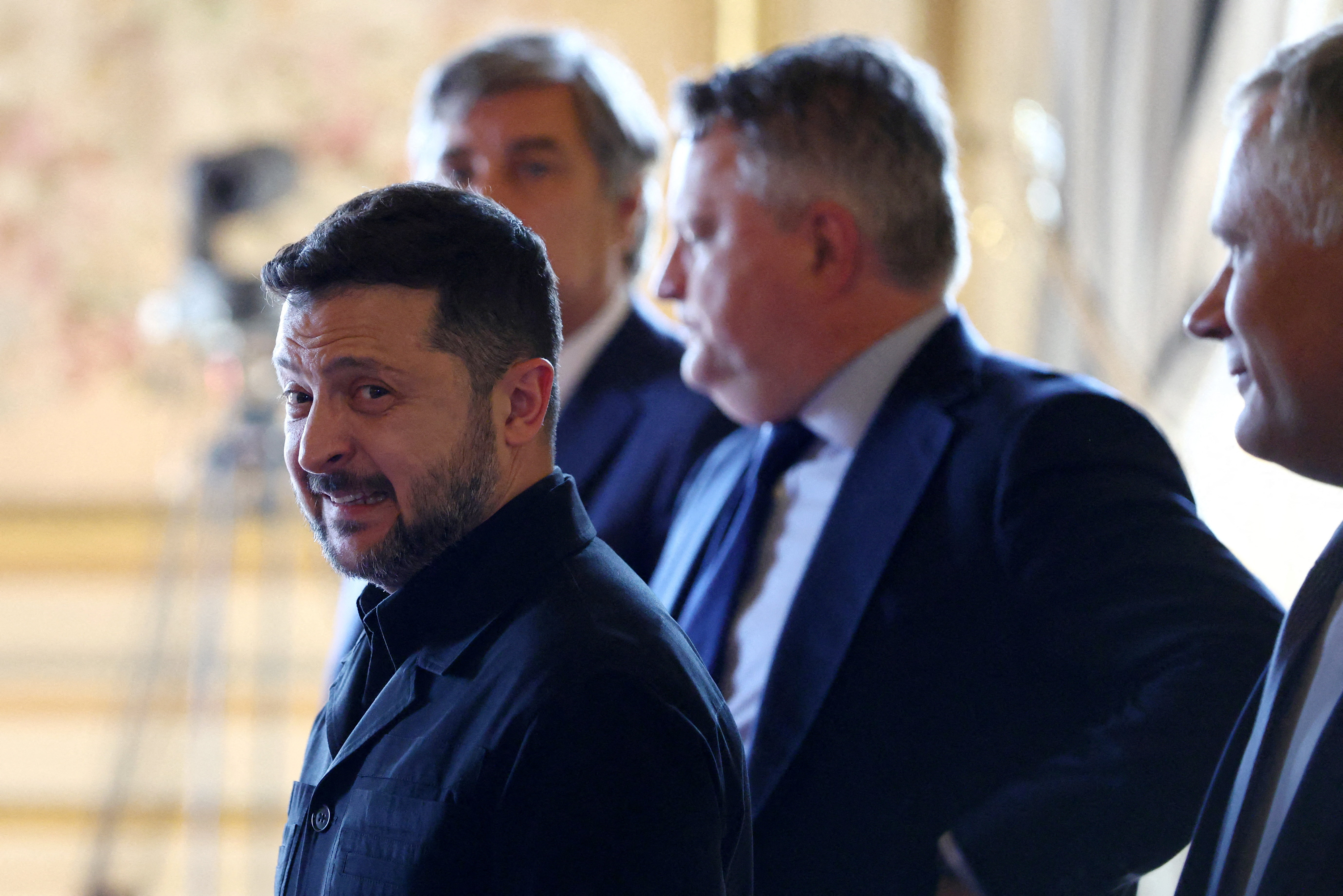 Ukraine's President Volodymyr Zelensky (L) arrives for the Integrated Anti-Ballistic Missile Coalition meeting ahead of a summit of the Coalition of the Willing to support Ukraine at the Hotel des Invalides in Paris on July 13, 2026.