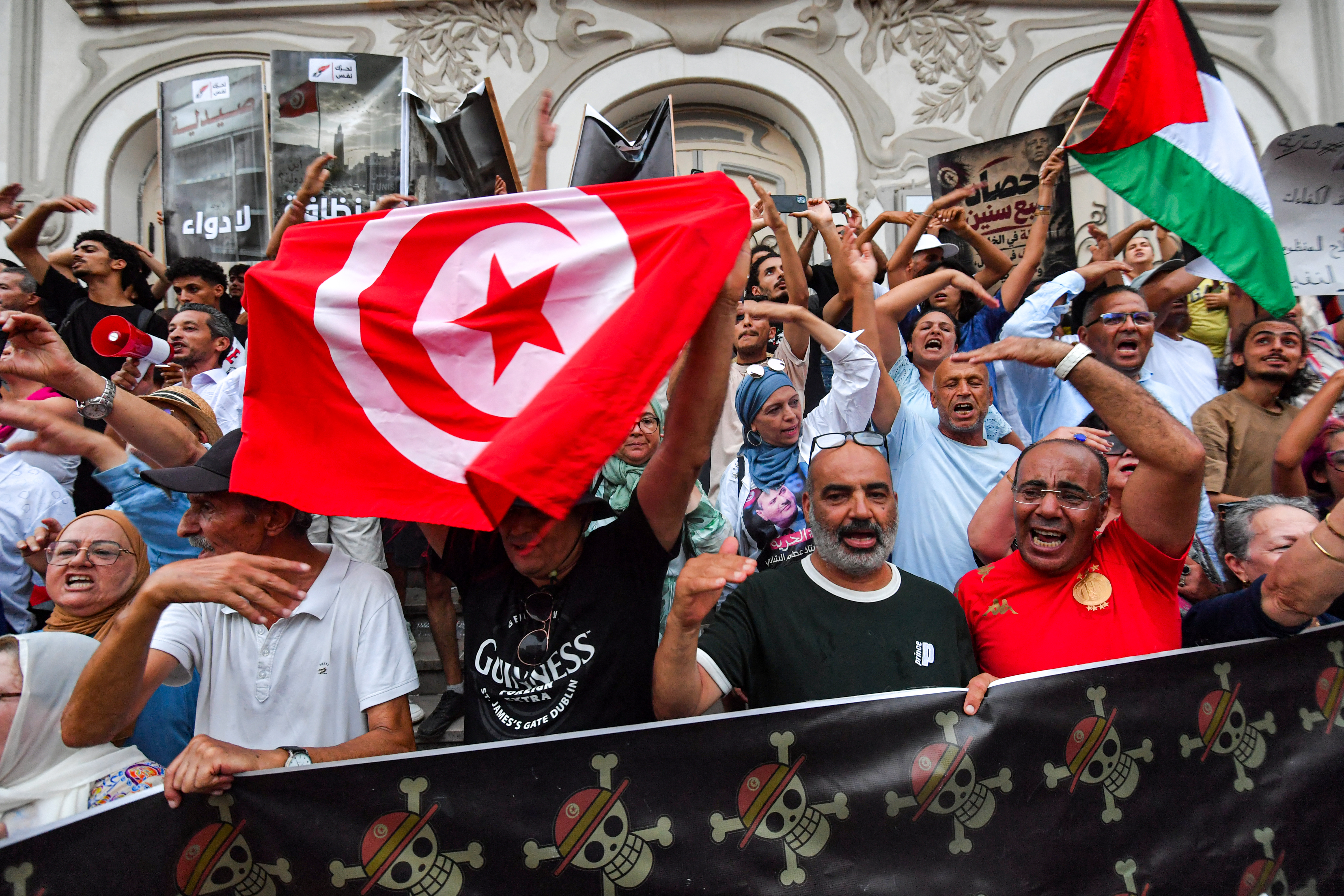 People gather to protest against Tunisia’s President Kais Saied during a demonstration marking five years since his suspension of parliament and assumption of emergency powers, along Avenue Habib Bourguiba in Tunis on July 25, 2026 [AFP]