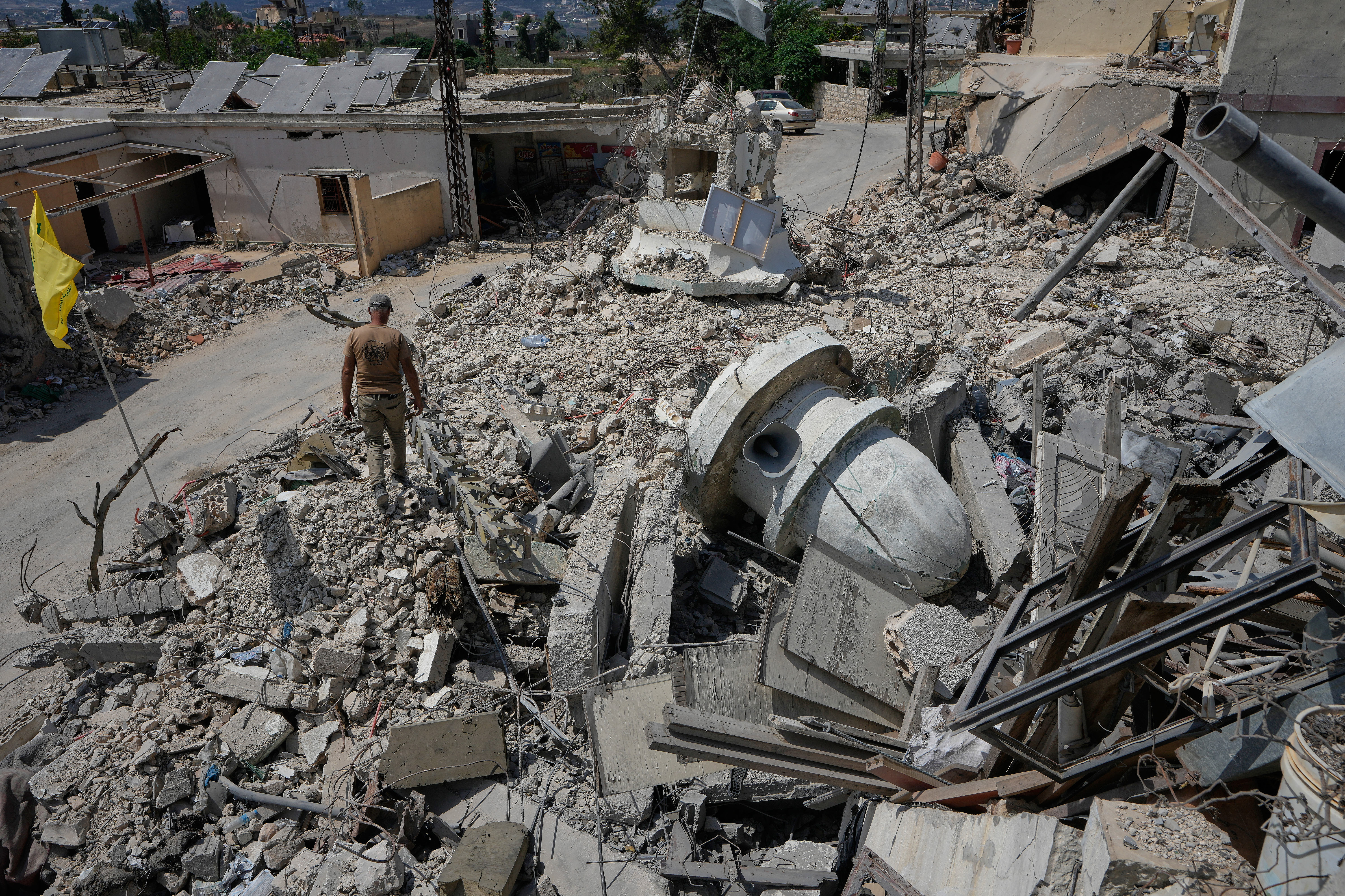 A Lebanese man walks on the rubble of a mosque that was destroyed in an Israeli strike during the war with Hezbollah in Froun village, southern Lebanon, Thursday, July 16, 2026. (AP Photo/Mohammed Zaatari)