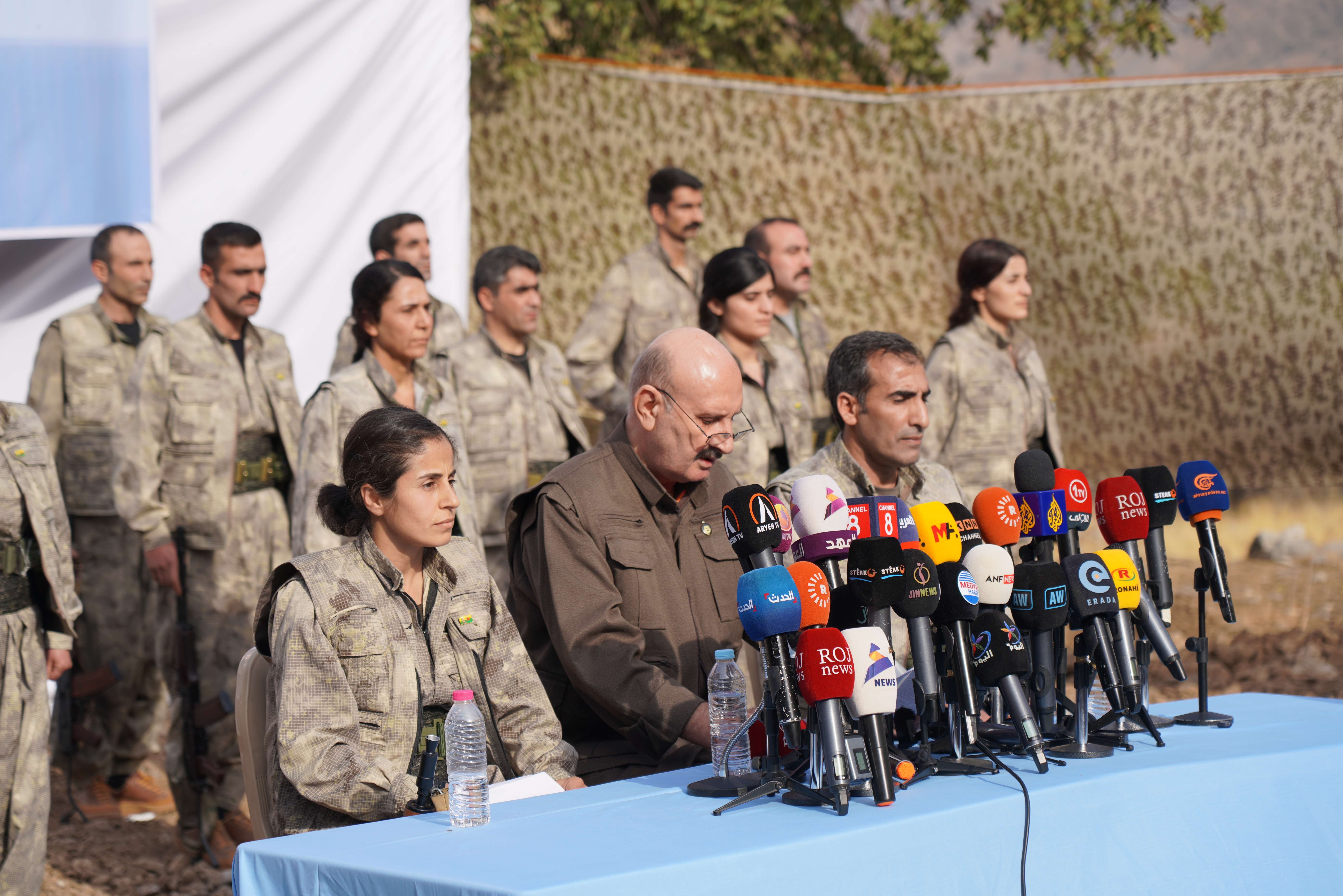 Kurdistan Workers’ Party fighters, who reportedly withdrew from Turkiye with their weapons, stand at attention during a ceremony in the Qandil area of northern Iraq in 2025