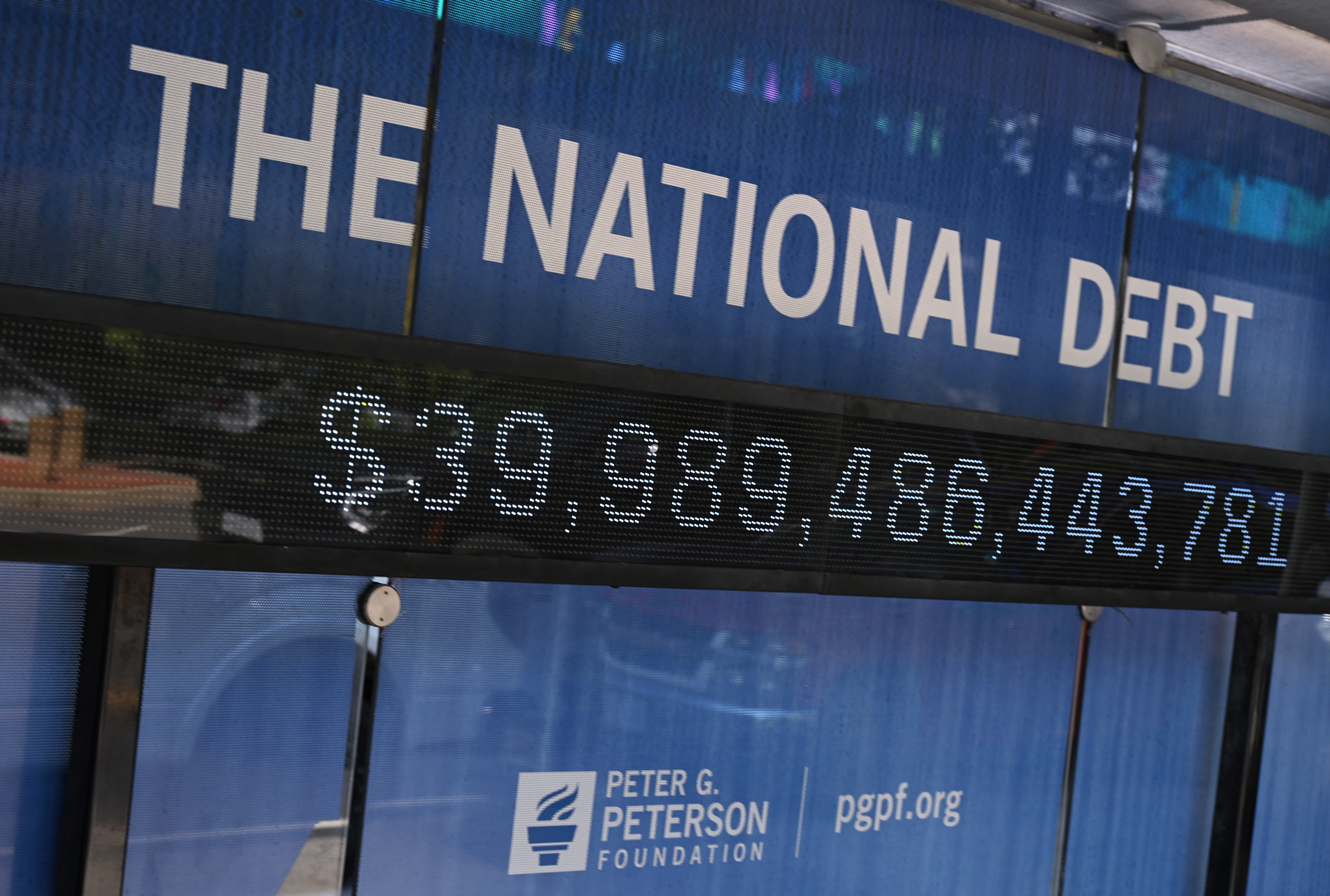 An electronic display shows the US national debt at a bus shelter in Washington, DC on August 19, 2026.