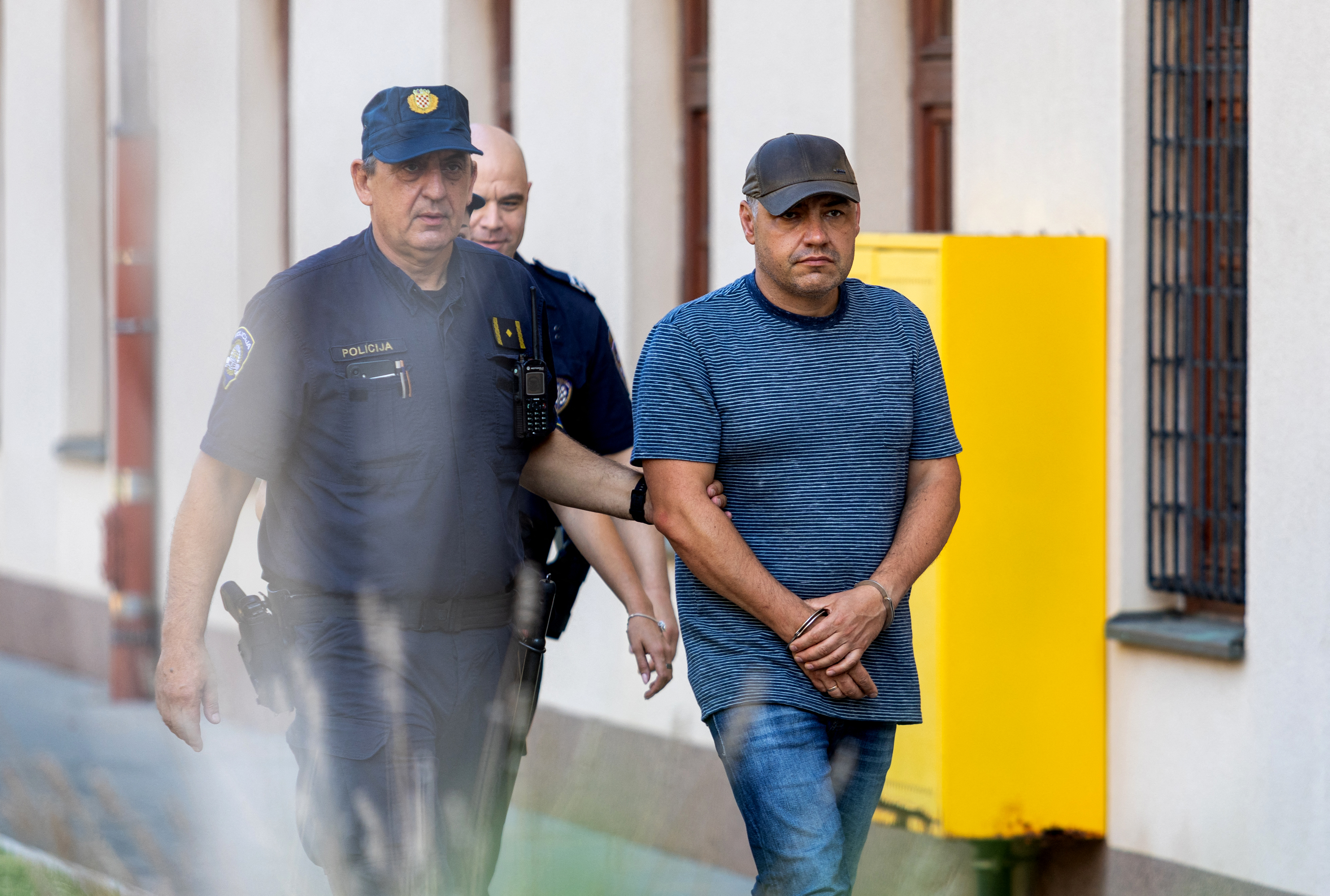 Croatian police escort Ukrainian national Volodymyr Zhuravlev, a professional diver suspected of involvement in the 2022 Nord Stream pipeline sabotage, towards a court appearance in Pula, Croatia, on August 20, 2026 [AFP]