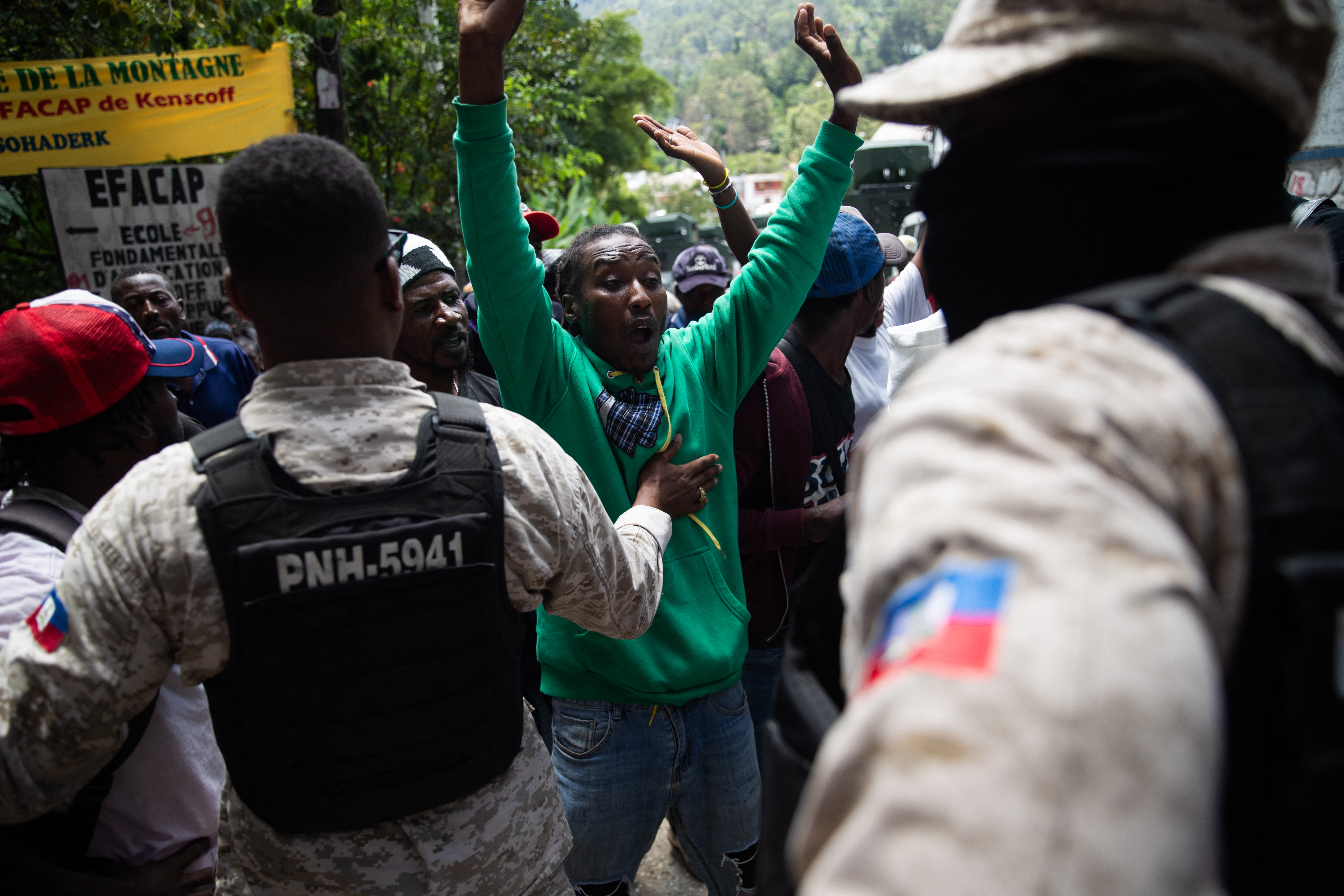 People react as law enforcement enters the area following overnight violence where more than twenty people were killed by armed gangs in Kenscoff, a neighborhood near Port-au-Prince, Haiti, on August 24, 2026.