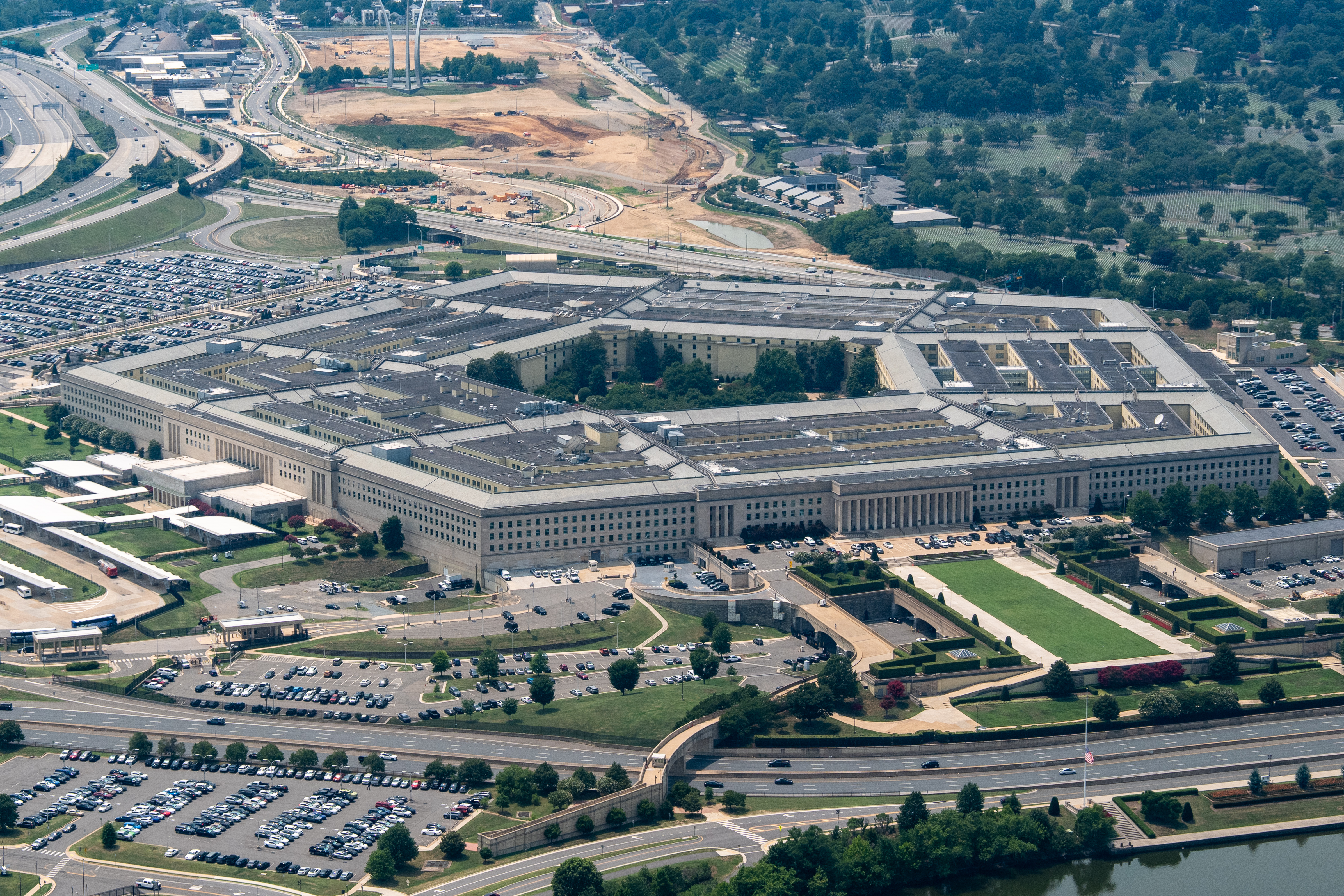 An aerial view of the five-sided Pentagon building surrounded by car parks and roads.