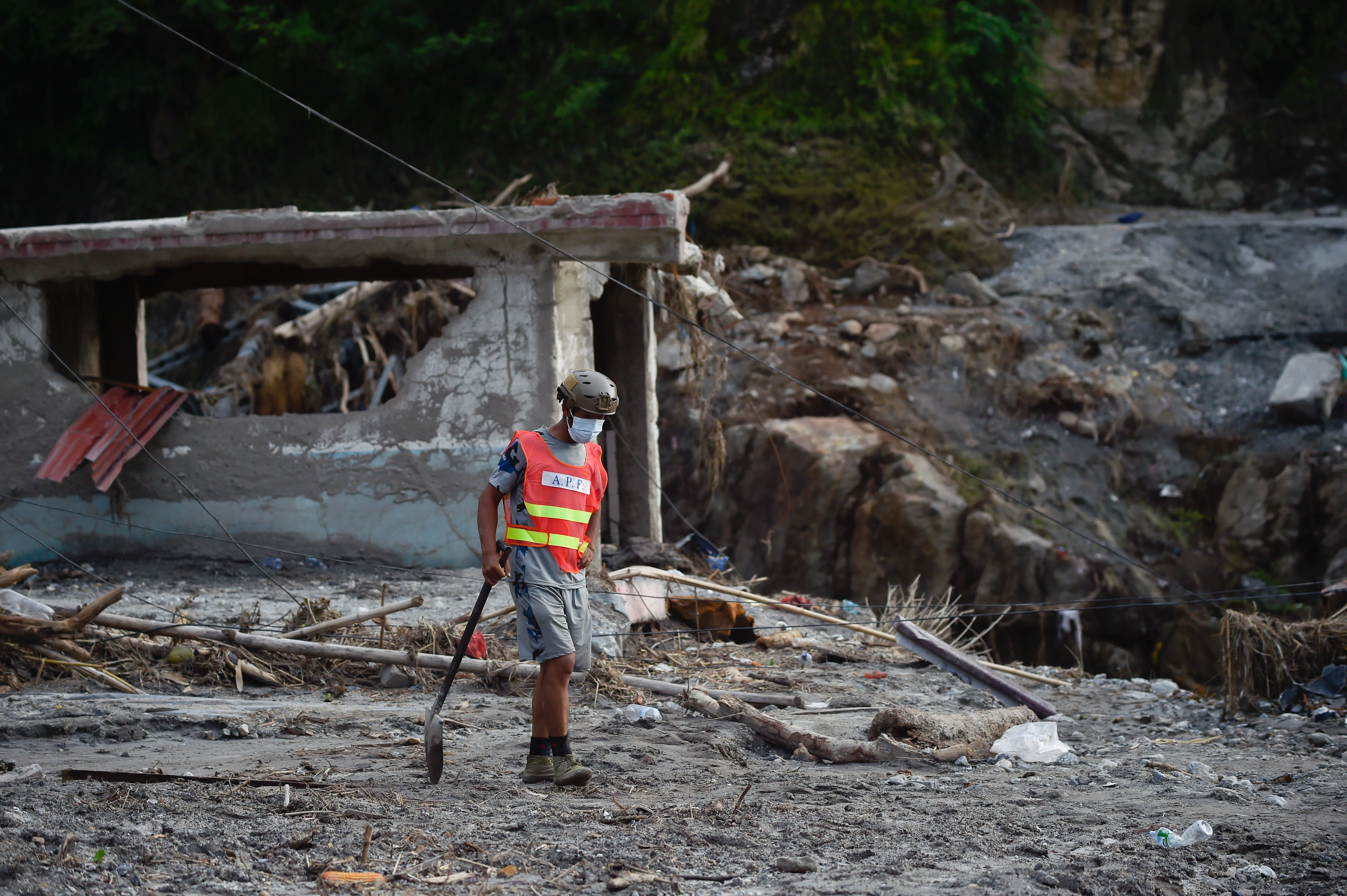 NUWAKOT, NEPAL - AUGUST 28: A Rescue team personnel searche through debris and mud covering an area following flash floods on August 28, 2026 in DeviGhat village, Nepal. Authorities said the flash floods were triggered after a mass of ice, mud and rock collapsed into a Himalayan river near the Nepal-China border, leaving hundreds dead or missing and causing widespread damage in affected districts. Authorities continued the gruelling search for victims, many buried under metres of mud, as both China and Nepal issued fresh flooding alerts. (Photo by Ritesh Shukla/Getty Images)
