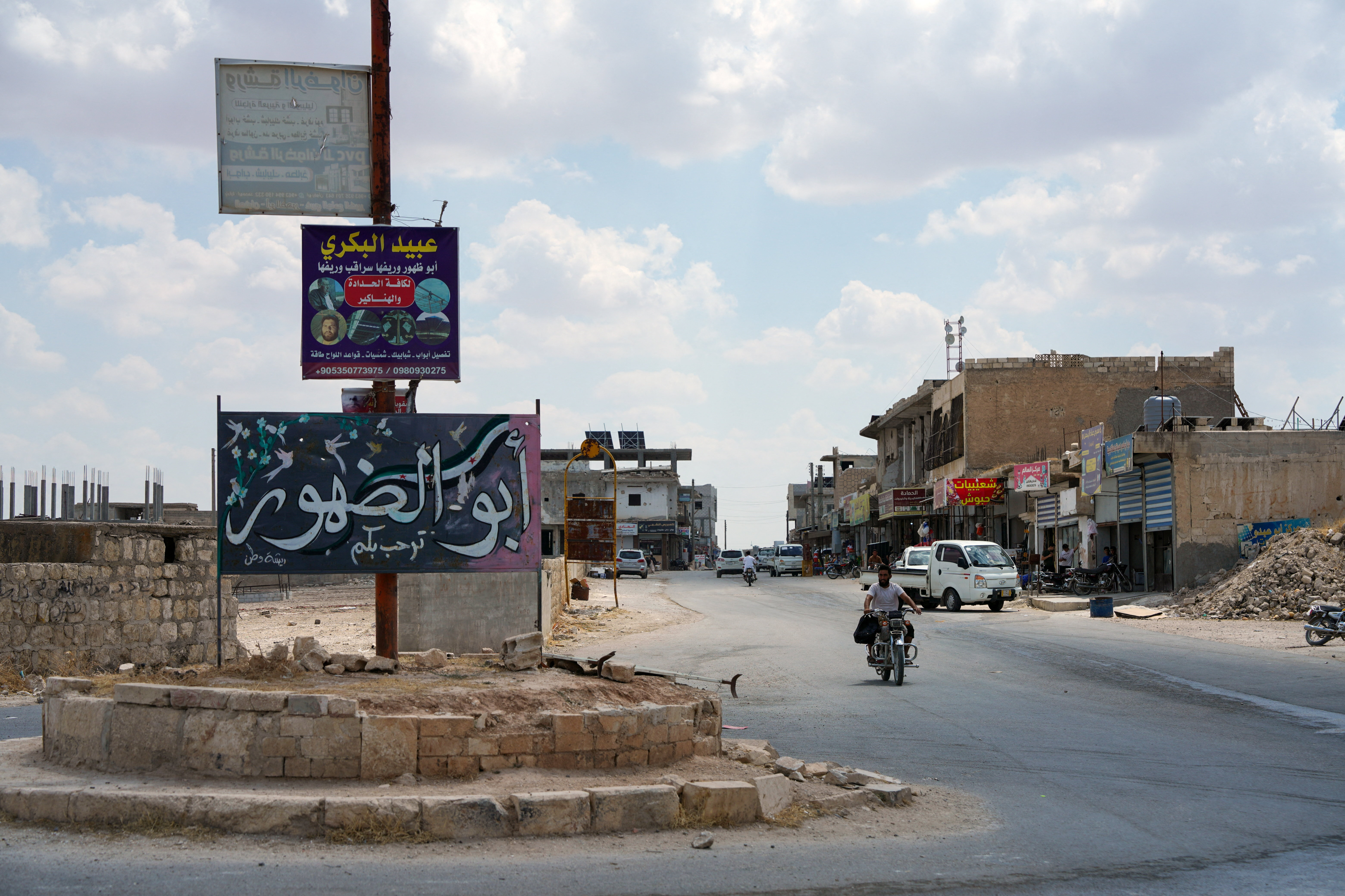 A man rides a motorbike in the town of Abu al-Duhur, Syria, August 18, 2026. REUTERS/Stringer