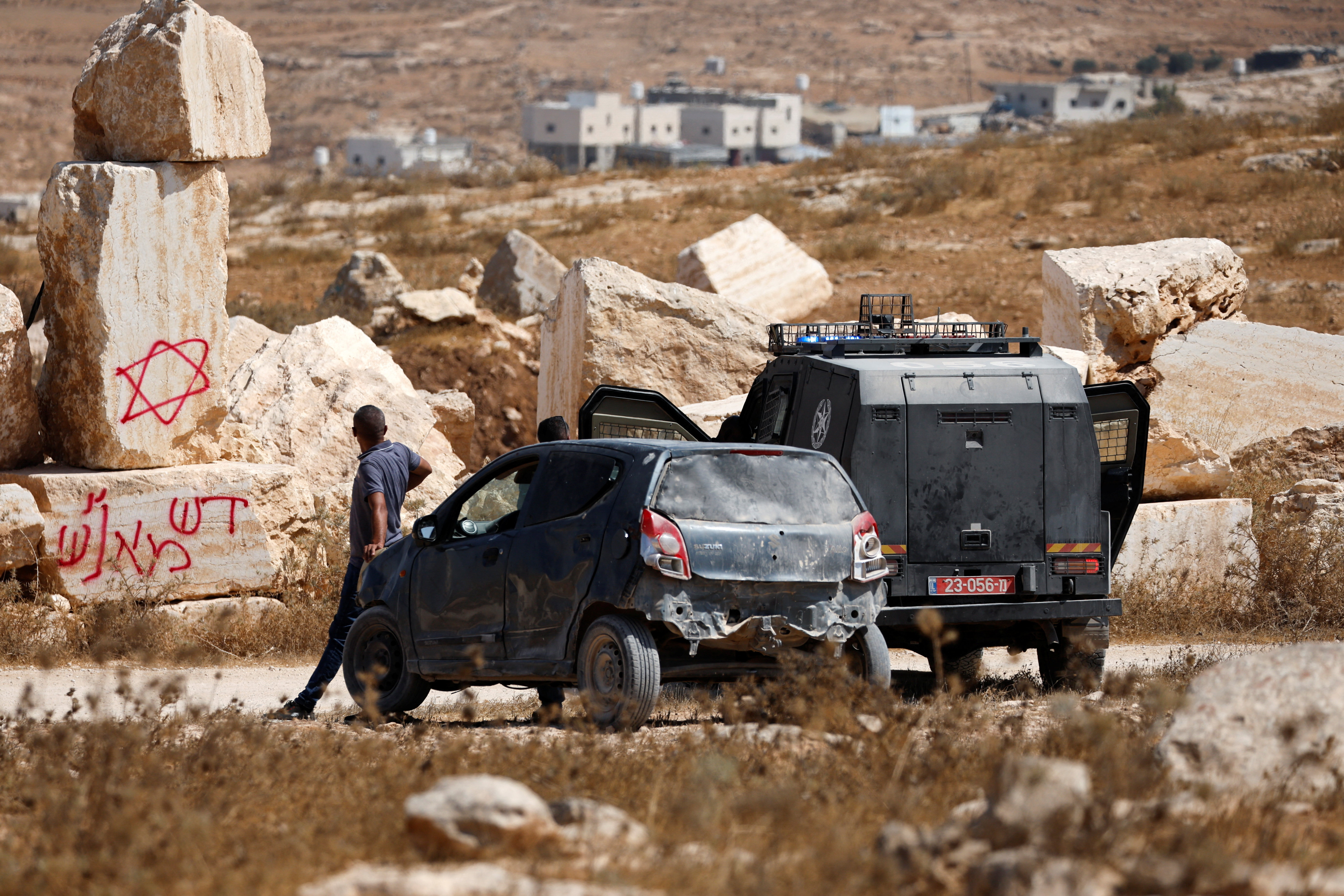 An Israeli police vehicle stands near the location where militant Israeli settlers set fire to stone quarry machinery, according to residents, near Hebron, in Israeli-occupied West Bank August 21, 2026. REUTERS/Mussa Qawasma