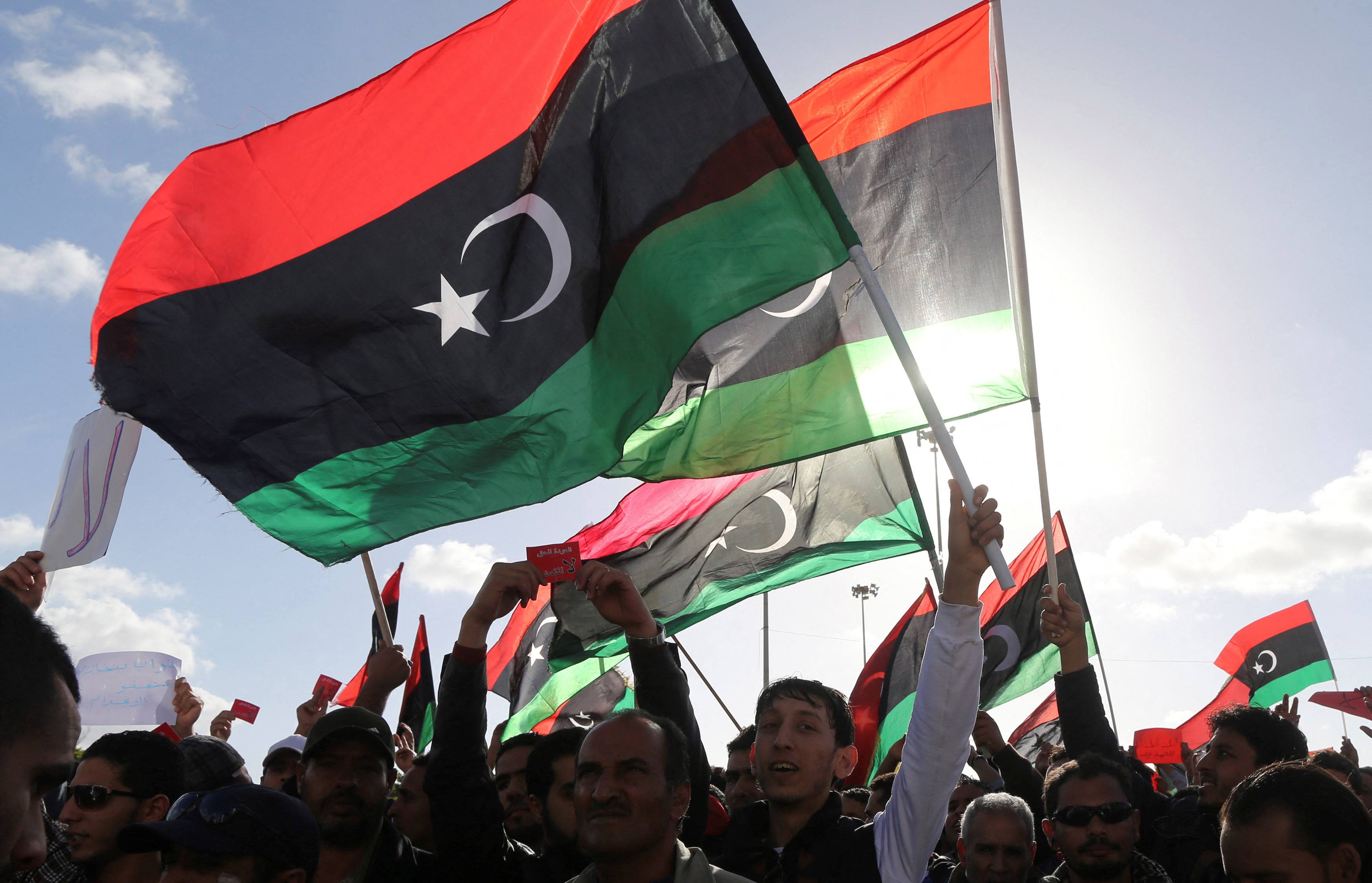 FILE PHOTO: People wave Libyan flags during a demonstration in Benghazi February 7, 2014. REUTERS/Esam Omran Al-Fetori/File Photo