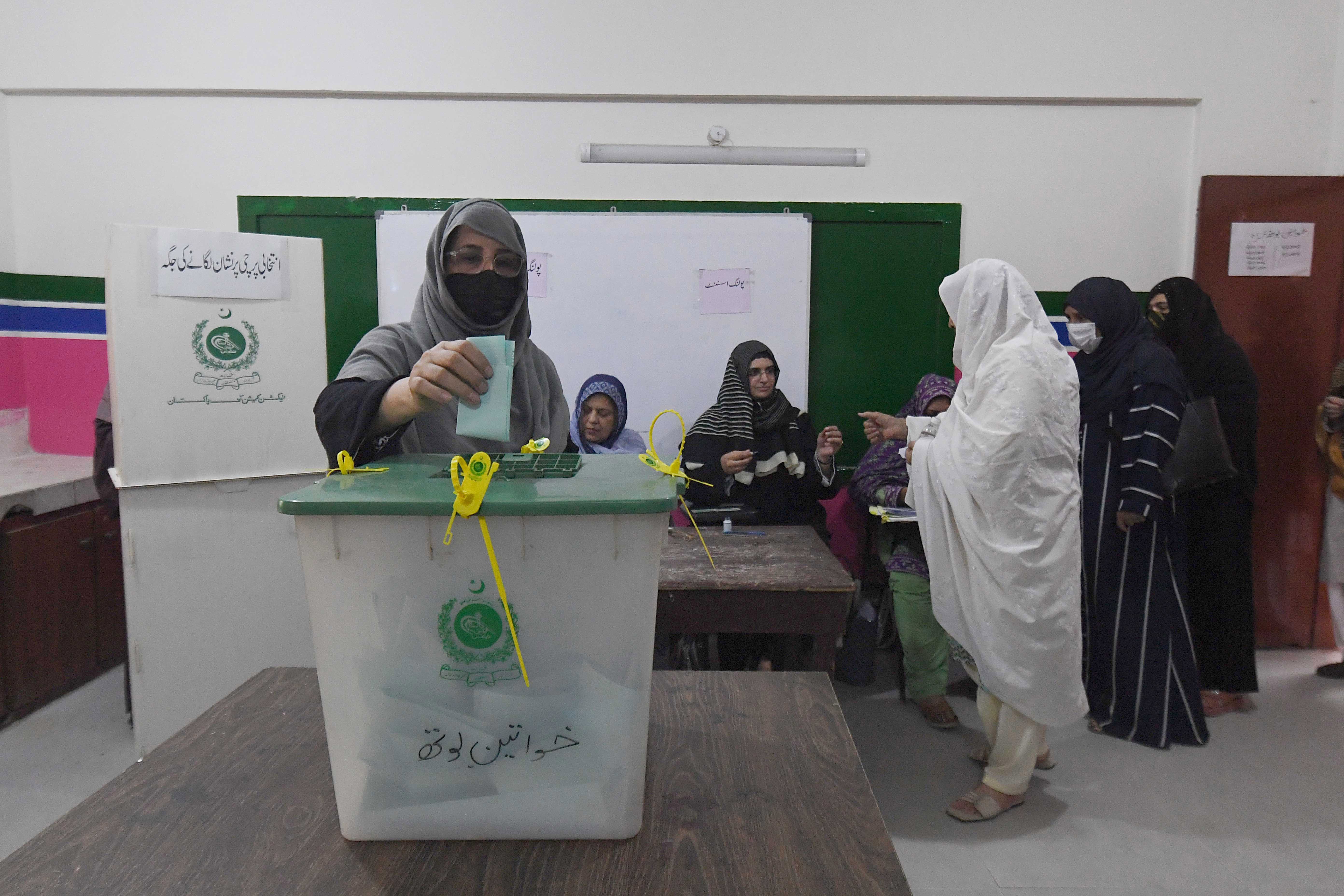 A woman casts her ballot.
