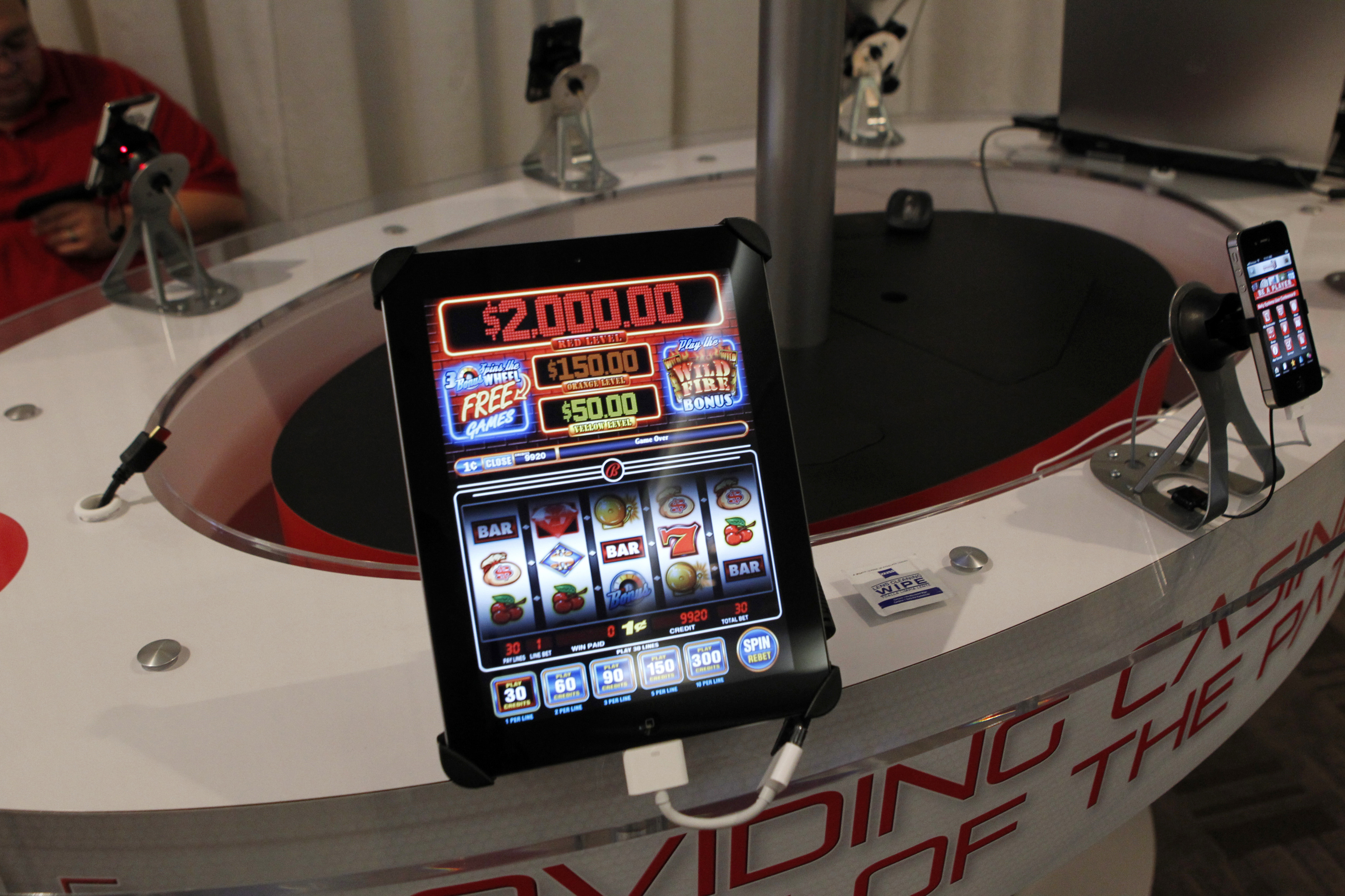 San Manuel Indian Bingo and Casino's online gambling app "Code Red" is demonstrated in the exhibitors room at the GiGse online gaming convention at the Westin hotel in San Francisco, California, April 24, 2012. Online poker is a business that involves processing billions of dollars worth of bets and battling the fraudsters, cheats and robot-player software that can ruin the games. Hence the casinos are cozying up to some tech-savvy offshore partners whose pedigrees might give regulators pause. Photo taken April 24, 2012. To match Special Report USA-POKER/GAMBLING REUTERS/Beck Diefenbach (UNITED STATES - Tags: BUSINESS ENTERTAINMENT)