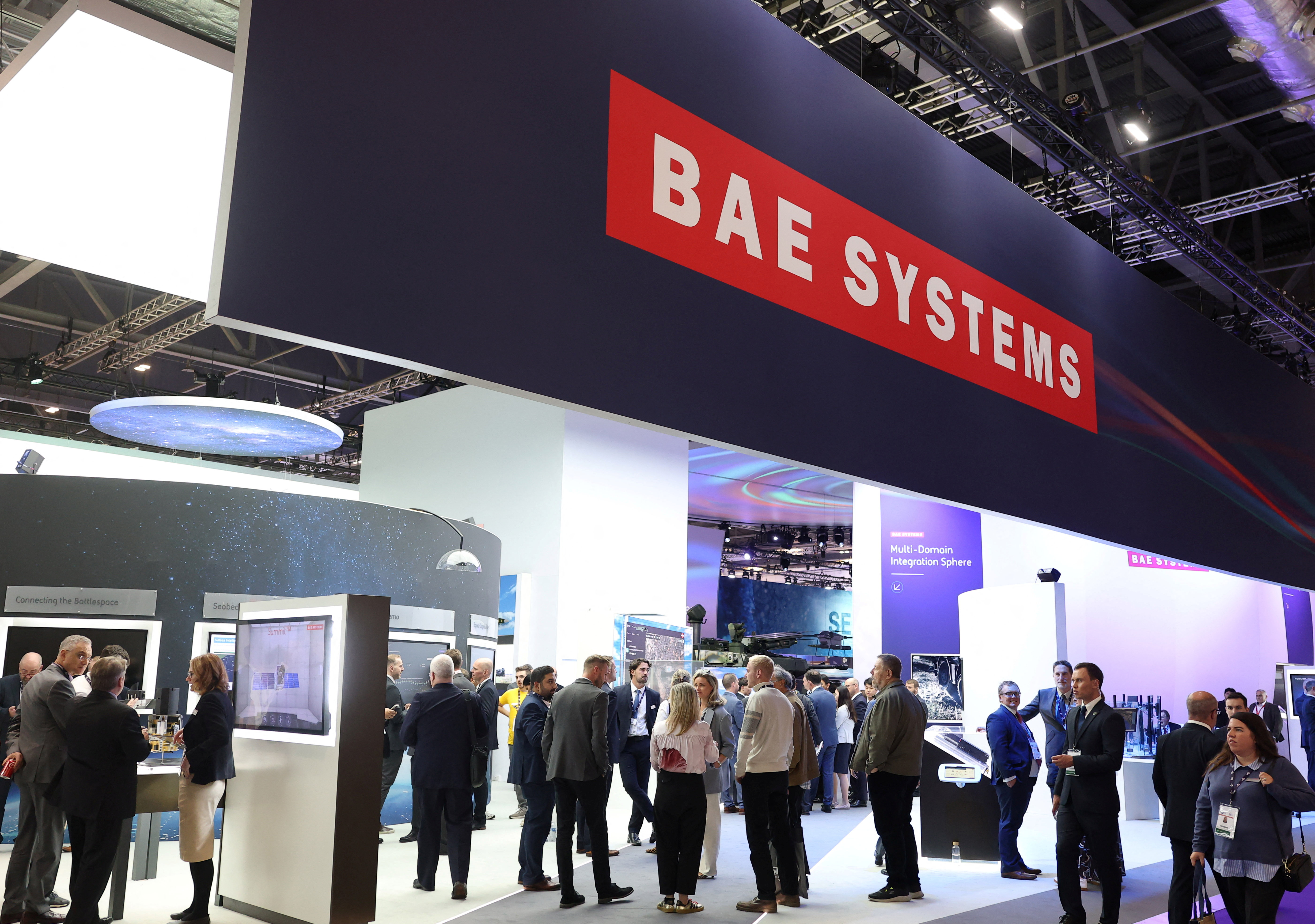 Visitors and exhibitors gather at the BAE Systems stand as they attend the Defence and Security Equipment International (DSEI) arms fair at the Excel exhibition centre in London, Britain, September 9, 2025. REUTERS/Toby Melville