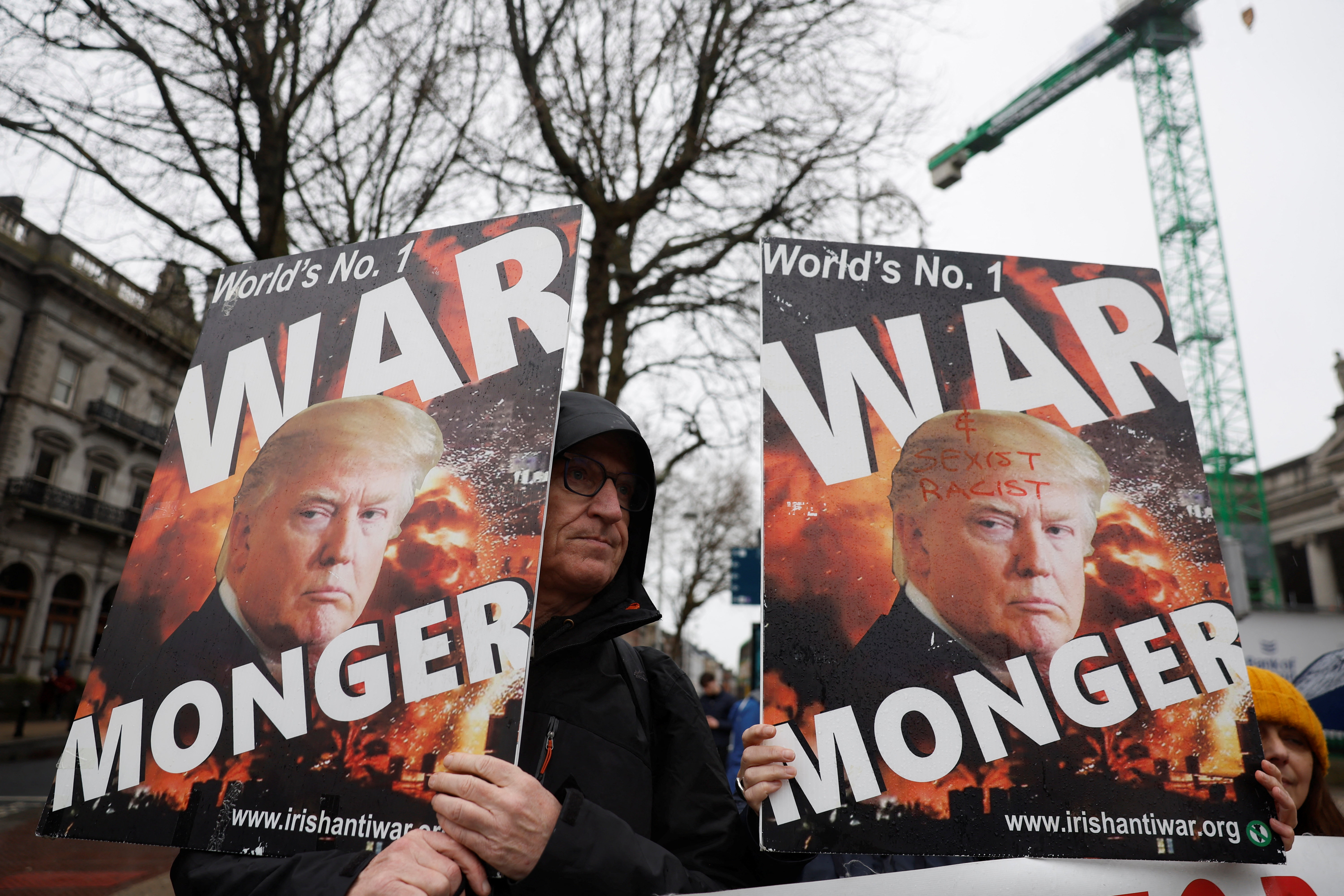 Demonstrators hold placards featuring U.S. President Donald Trump, in support of Palestinians during a protest in relation to the ceasefire in Gaza, in Dublin, Ireland, February 21, 2026. REUTERS/Clodagh Kilcoyne