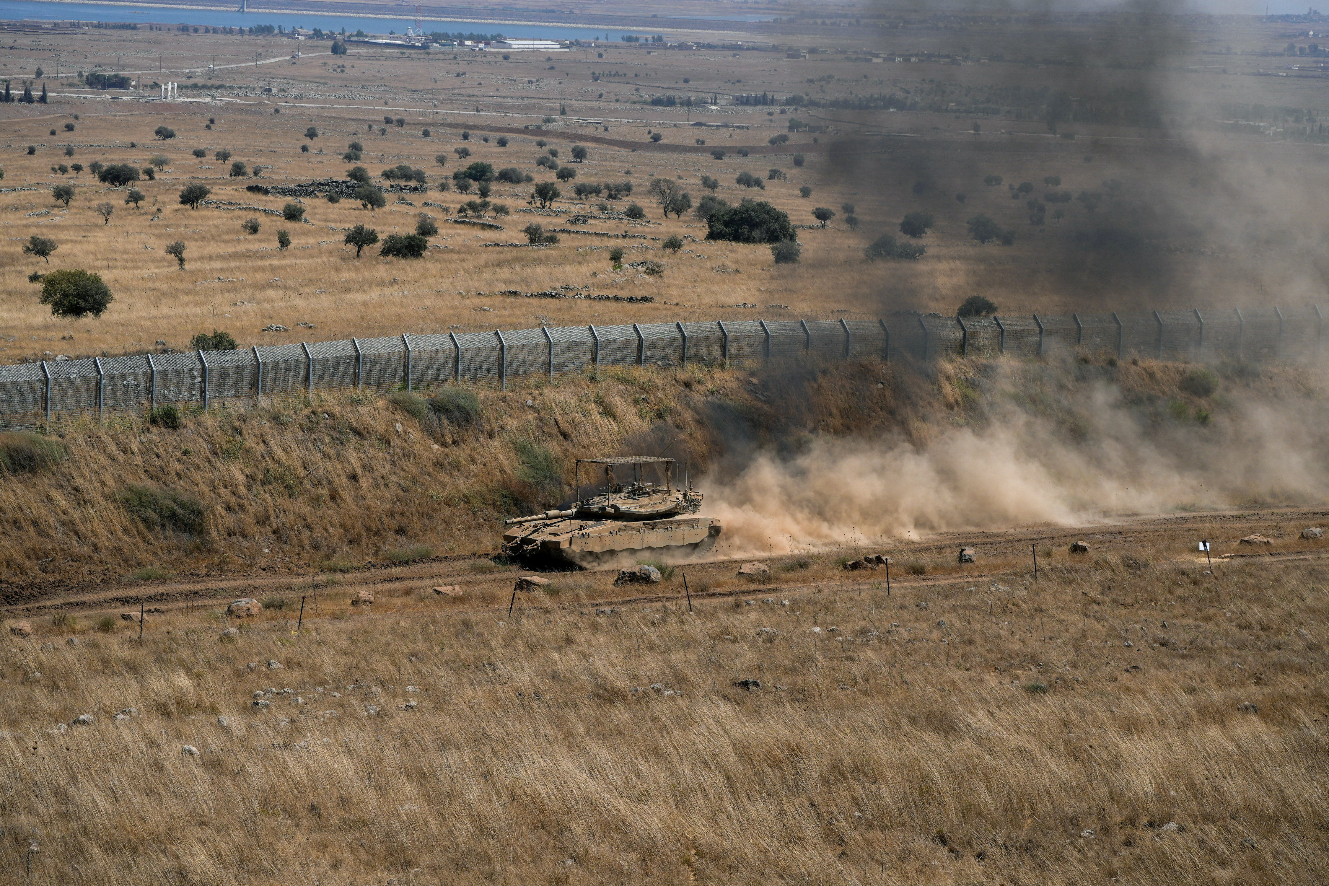 FILE PHOTO: An Israeli tank drives along the ceasefire line between the Israeli-occupied Golan Heights and Syria, on its Israeli side August 20, 2026. REUTERS/Ayal Margolin/File Photo