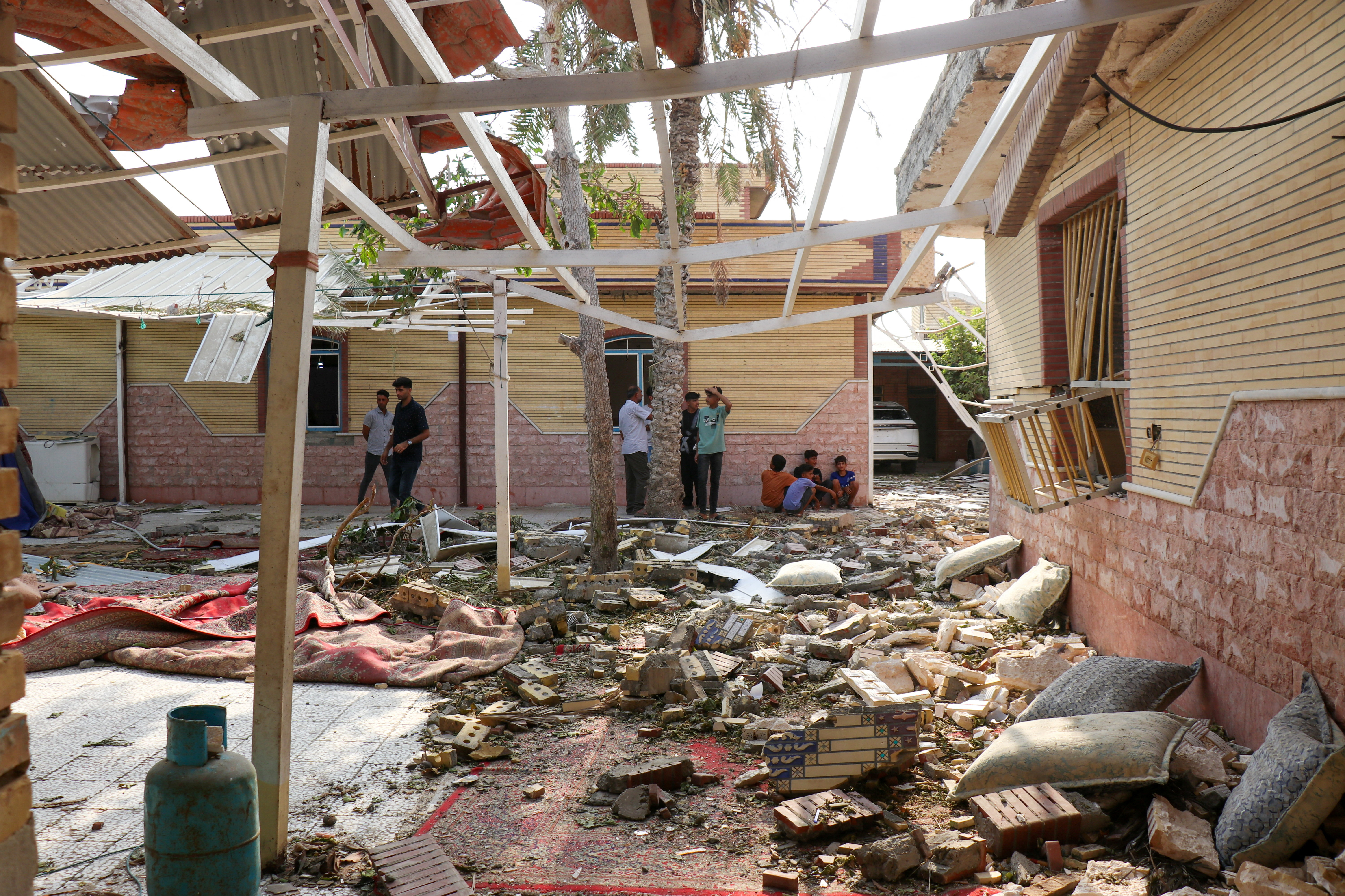 Rubble lies around damaged houses.