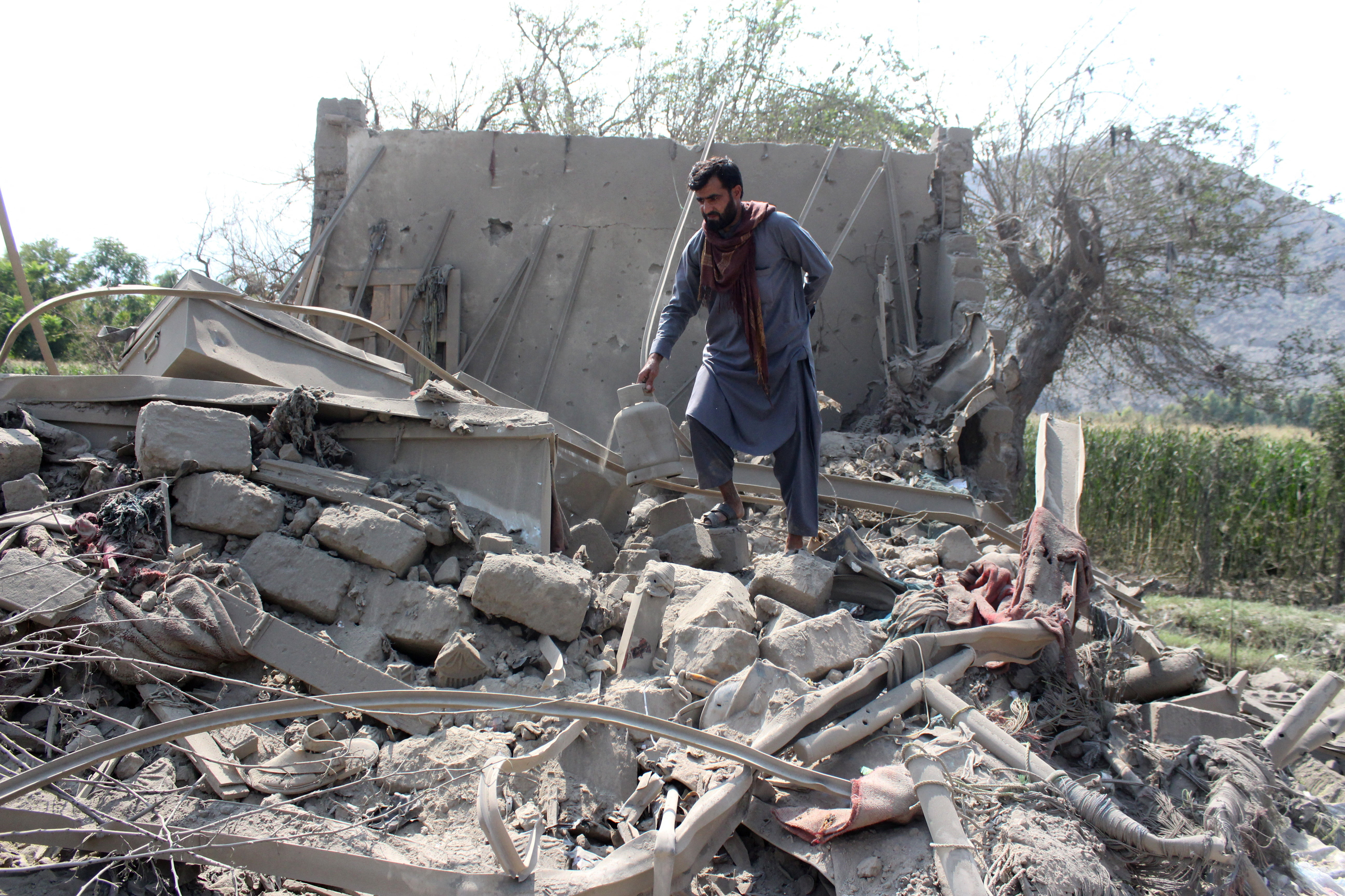 A man retrieves belongings from the debris of a house that was damaged in what the Taliban said was a Pakistani airstrike in Kunar province, Afghanistan, September 21, 2026 [Reuters]