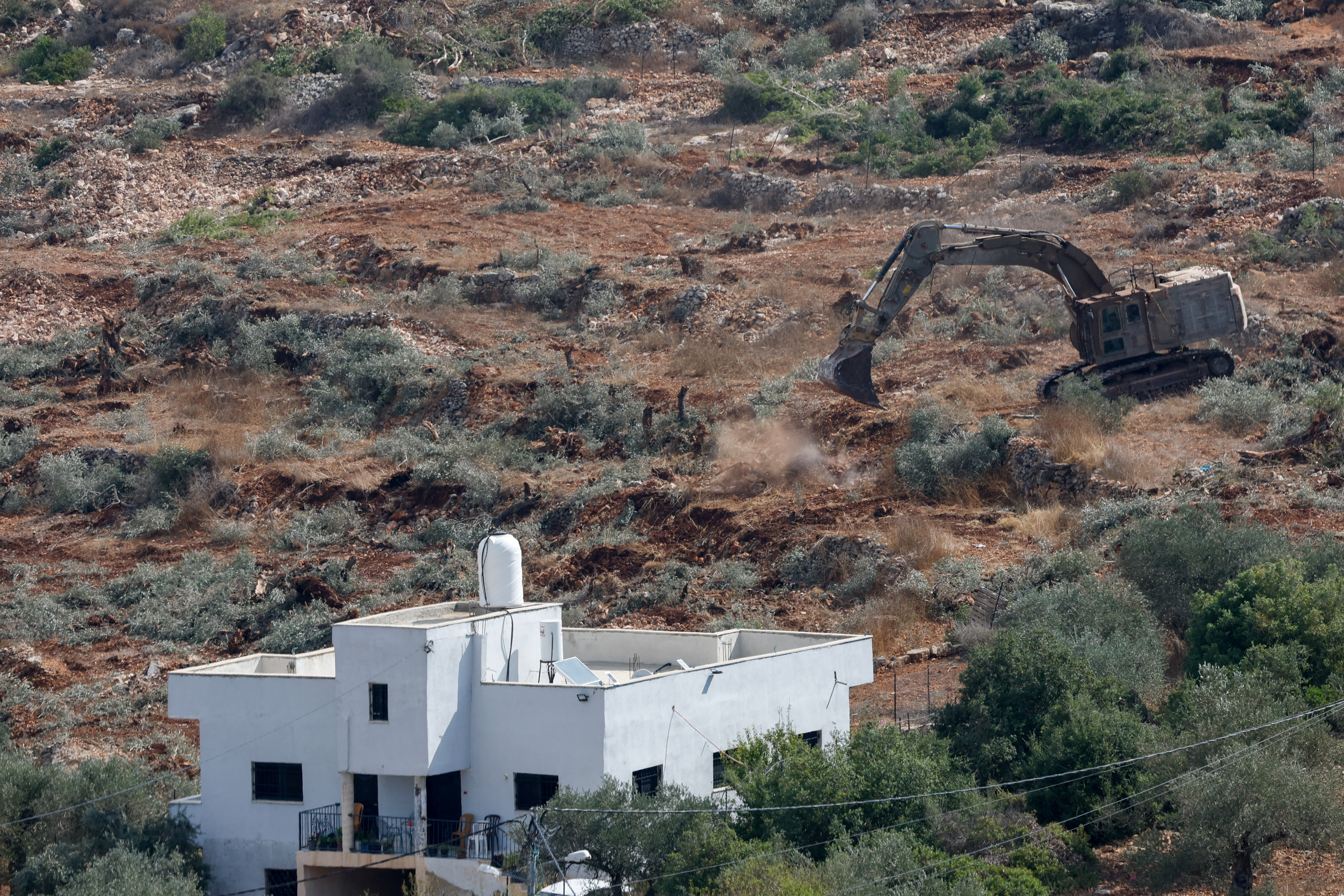 Israeli military machinery uproots olive trees near the Palestinian village of Deir Nizam near Ramallah, in the occupied West Bank, September 23, 2026 [Mohammed Torokman/Reuters]