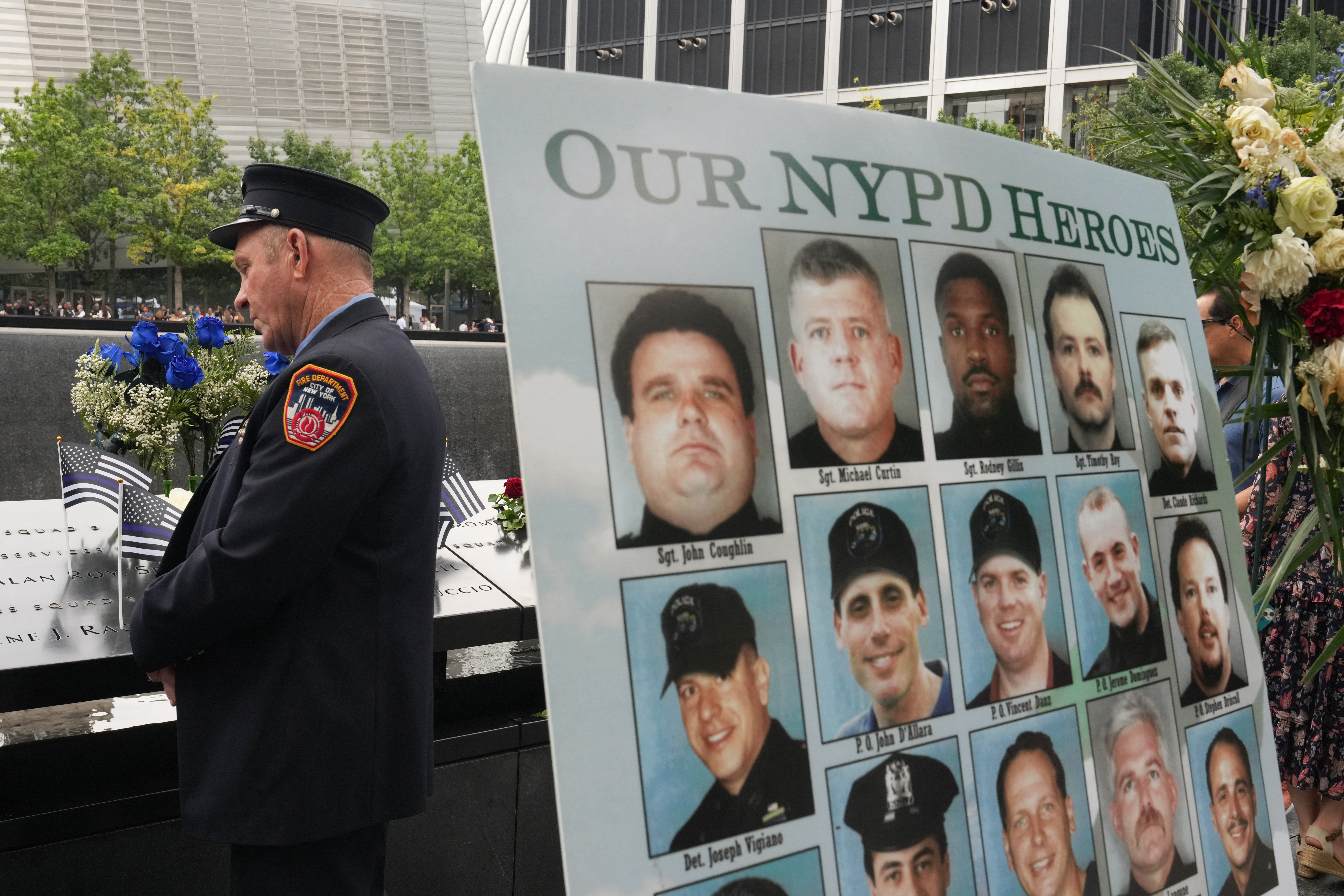 A New York Police Department (NYPD) officer pays his respects at the National September 11 Memorial during the 25th anniversary commemoration of the September 11, 2001 attacks in New York on September 11, 2026. (Photo by DAVID DEE DELGADO / POOL / AFP)