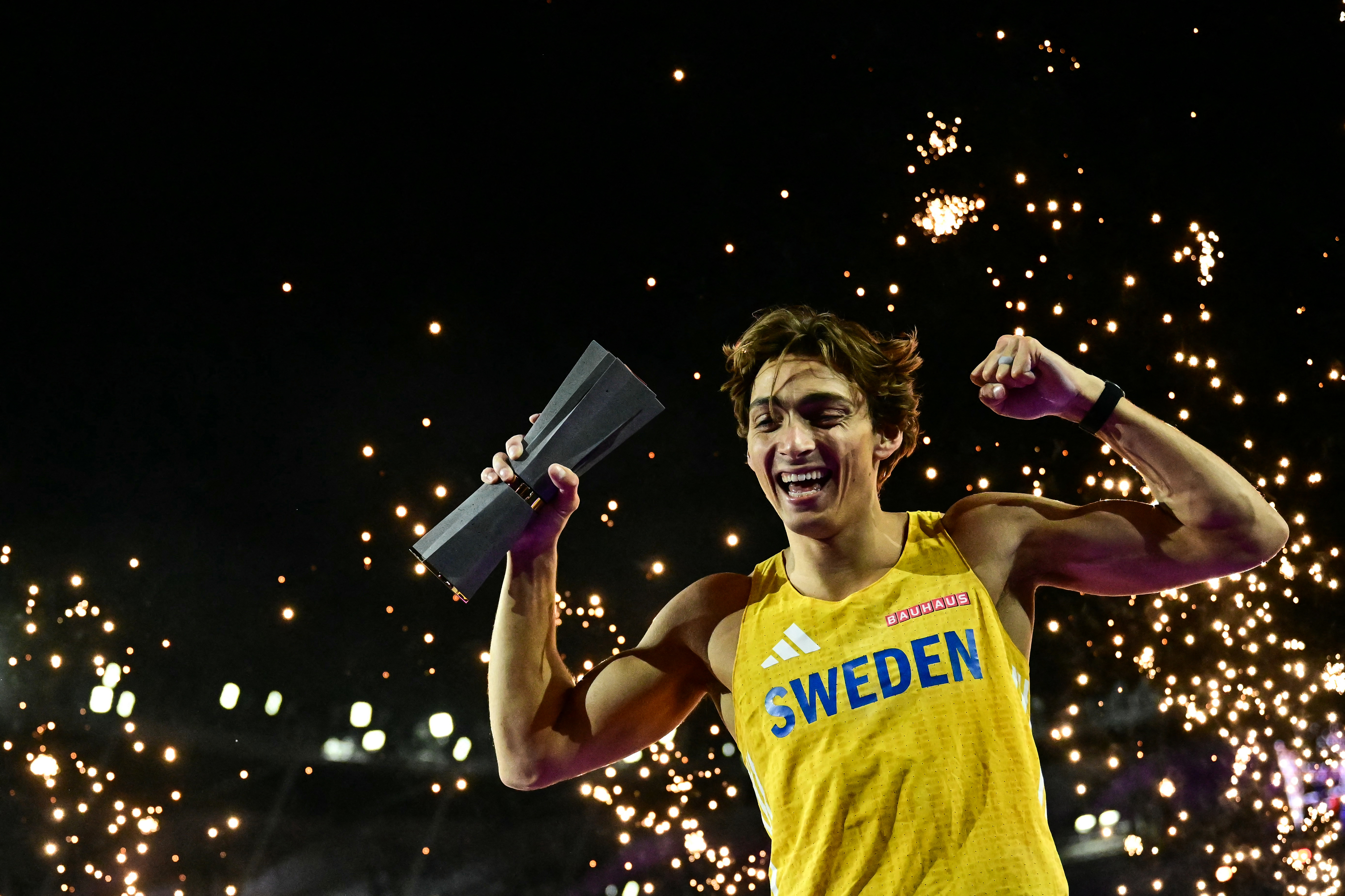 Sweden's Armand Duplantis celebrates with the trophy after his victory in men's pole vault final during the World Athletics Ultimate Championship at the Gyula Zsivotzky National Athletics Centre, in Budapest on September 11, 2026. (Photo by Ben STANSALL / AFP)