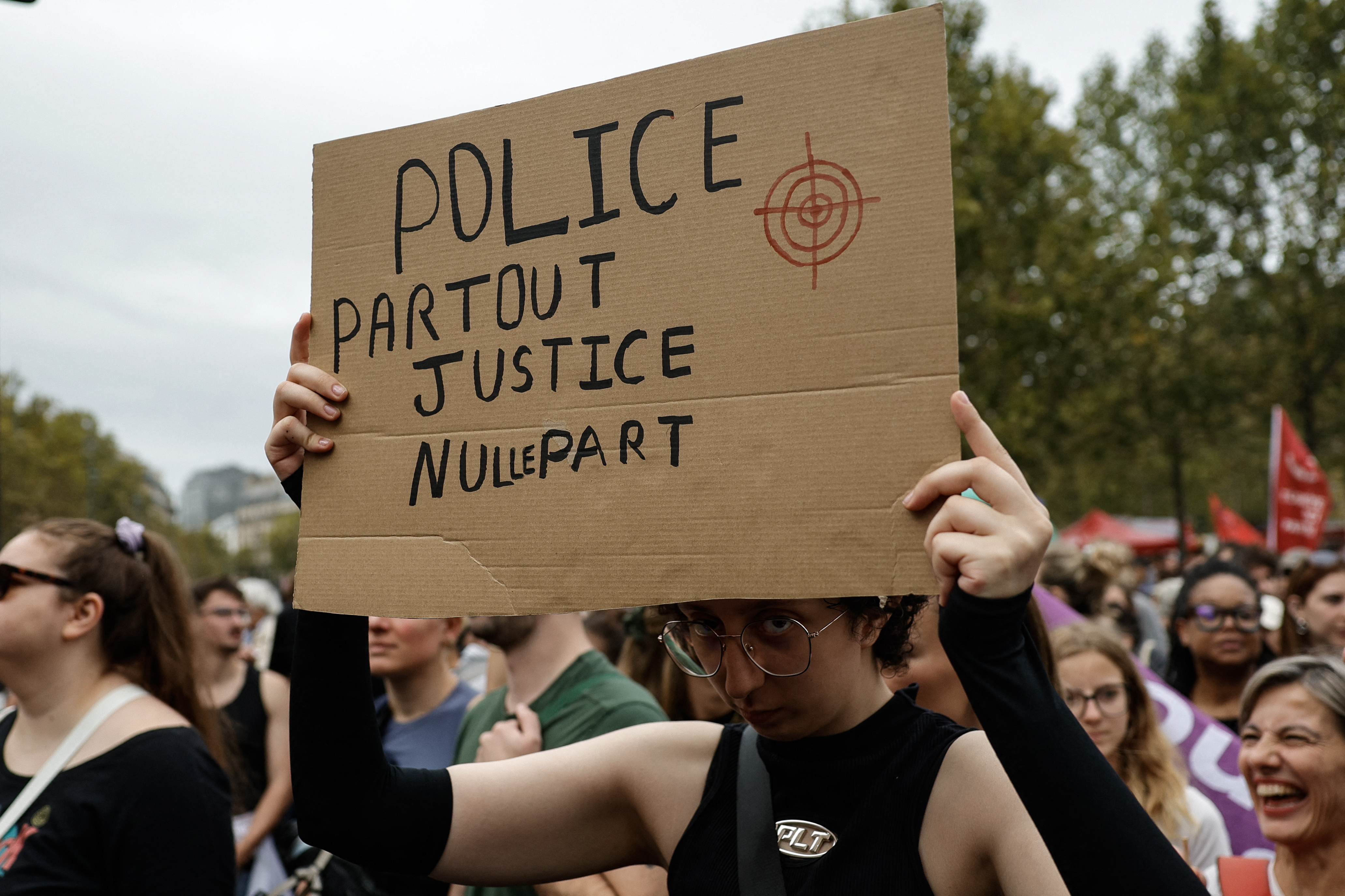 A protester with a placard which reads "police everywhere, justice nowhere" takes part in a march against the bill dubbed the "permis de tuer" (license to kill) in Paris, France on September 20, 2026.