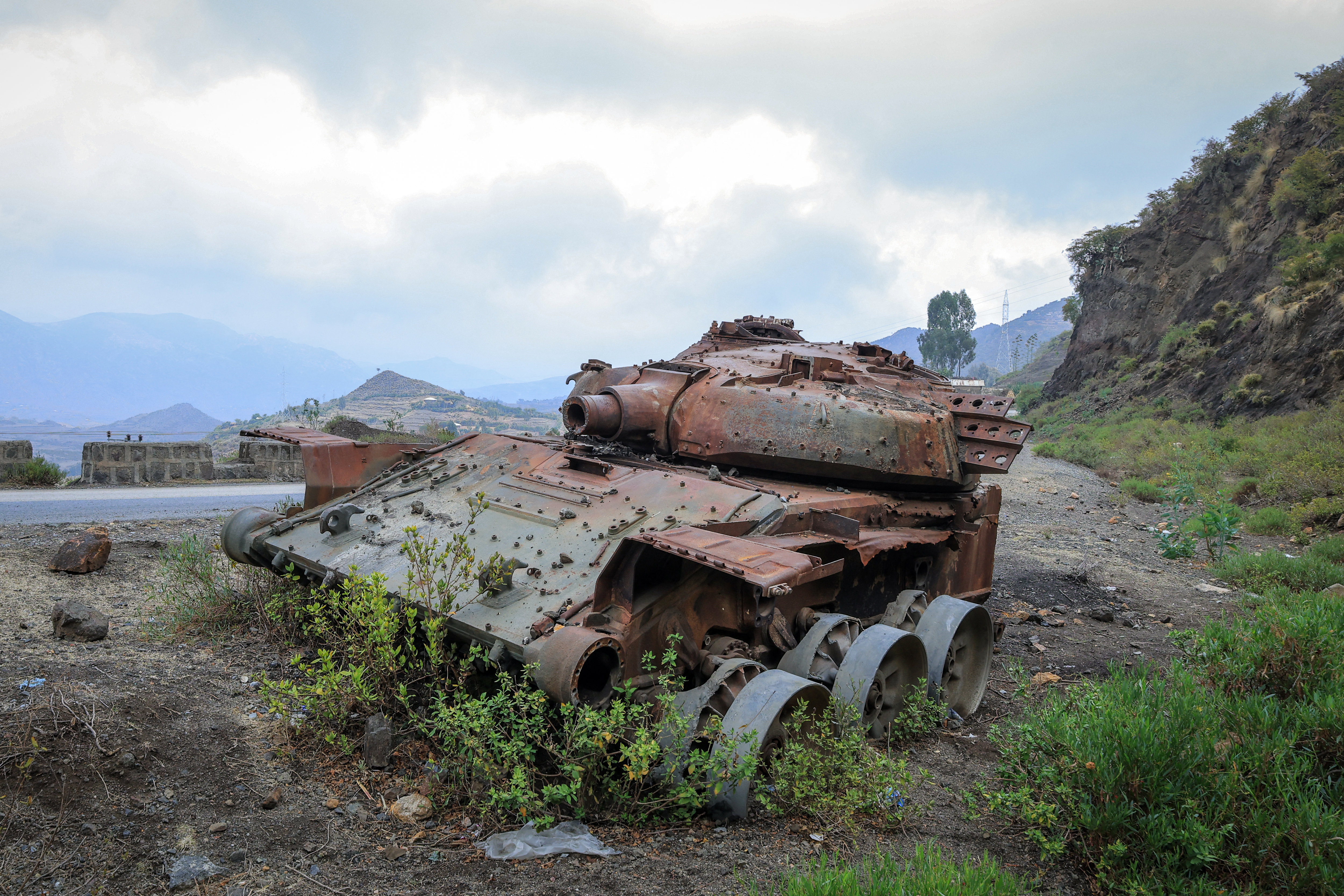 The charred remains of a tank lie on a road near Gereb Agew, southern Tigray, after clashes between the Ethiopian National Defence Force (ENDF) and the Tigray People’s Liberation Front (TPLF), on March 3, 2026 [File: Abel Gerezgiher/AFP]