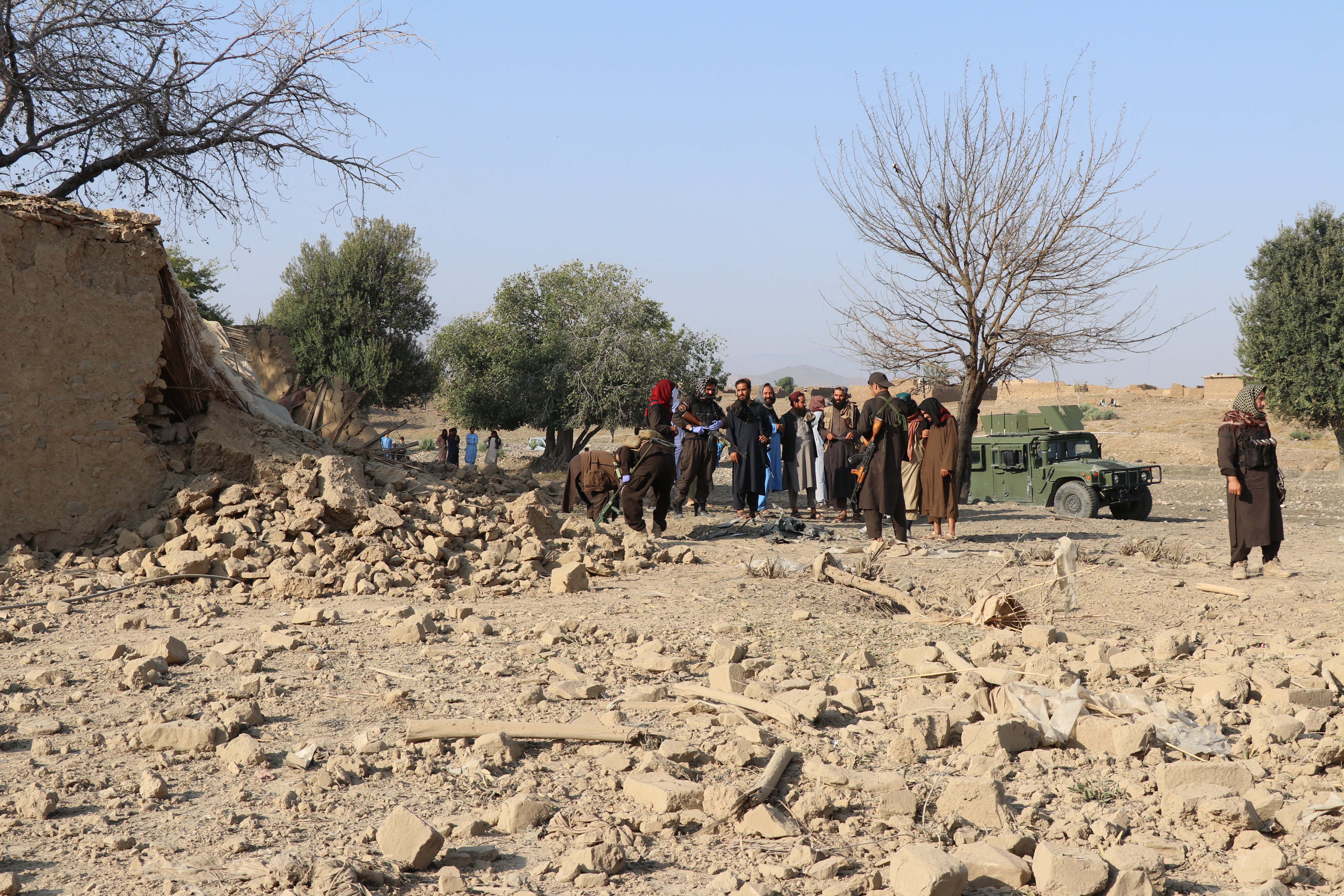 Security personnel inspects the site of a strike in Gurbuz district in Afghanistan's Khost province