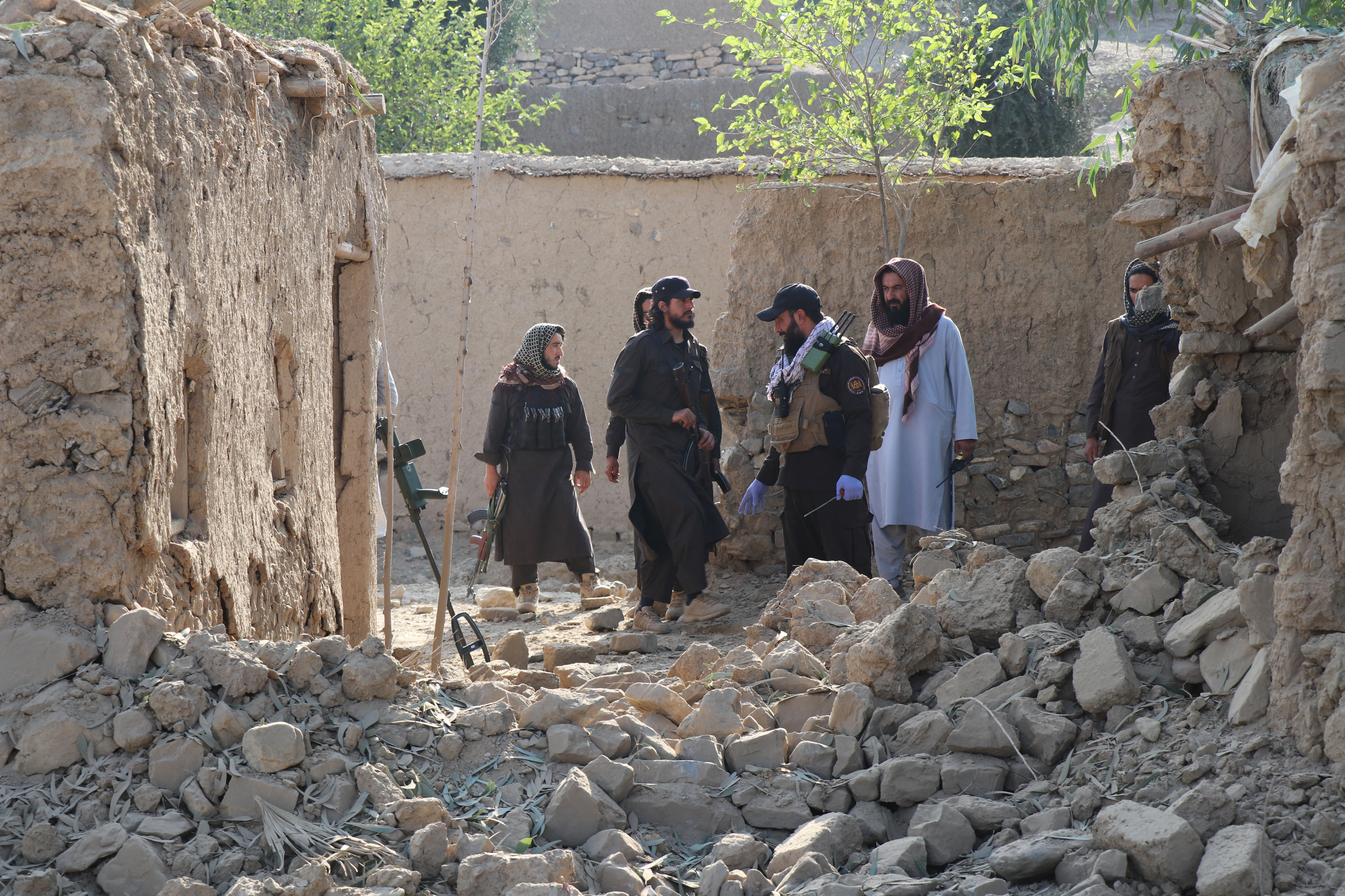 Security personnel inspects the site of a strike in Gurbuz district in Afghanistan's Khost province
