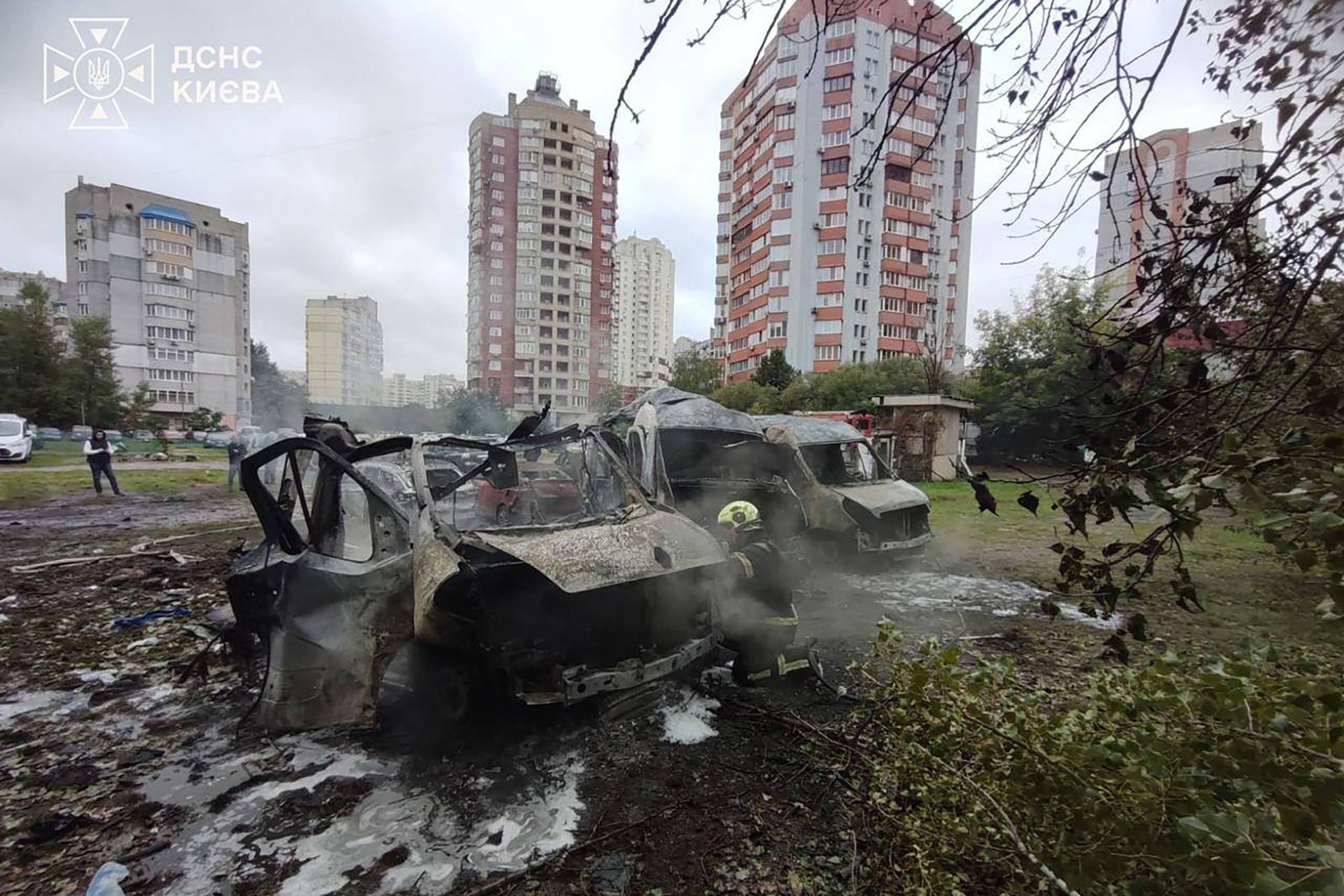 burnt-out cars at the site of an air attack in Kyiv,